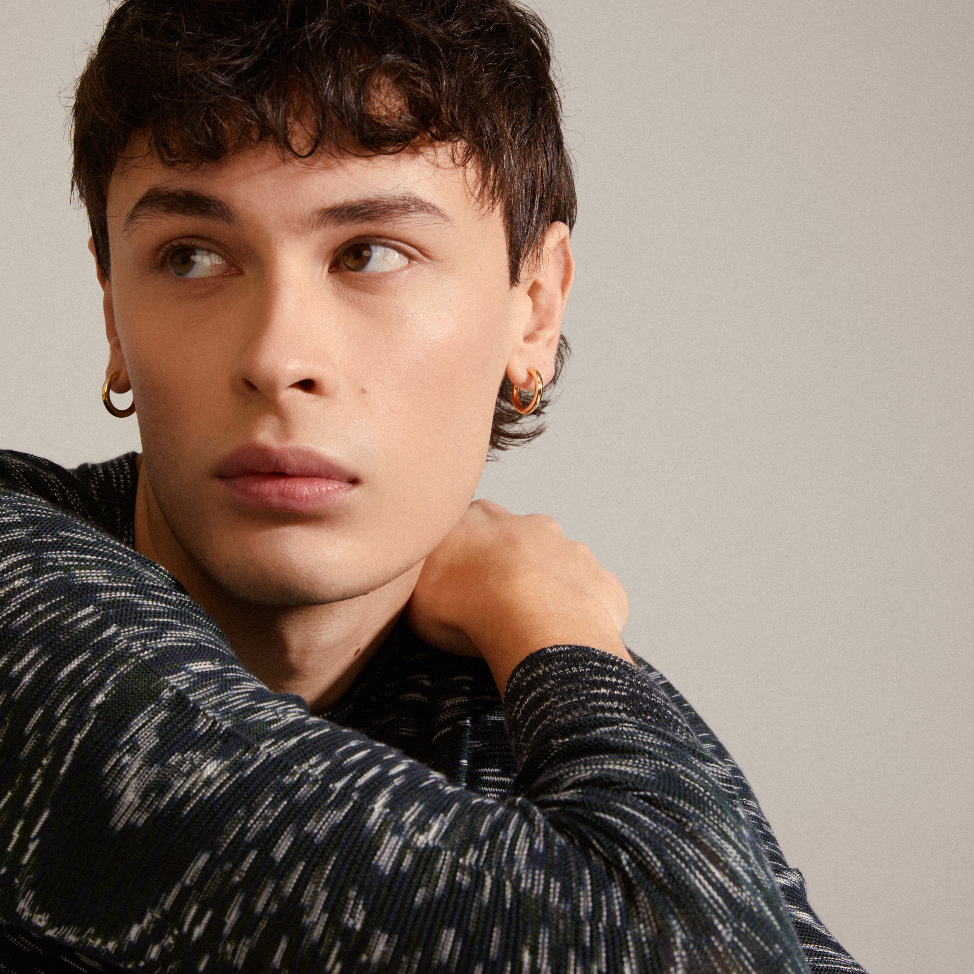 DOLAG earrings gold-plated, showcased on a man, highlighting their chunky, smooth, shiny finish, perfect for trendy, personal style seekers.