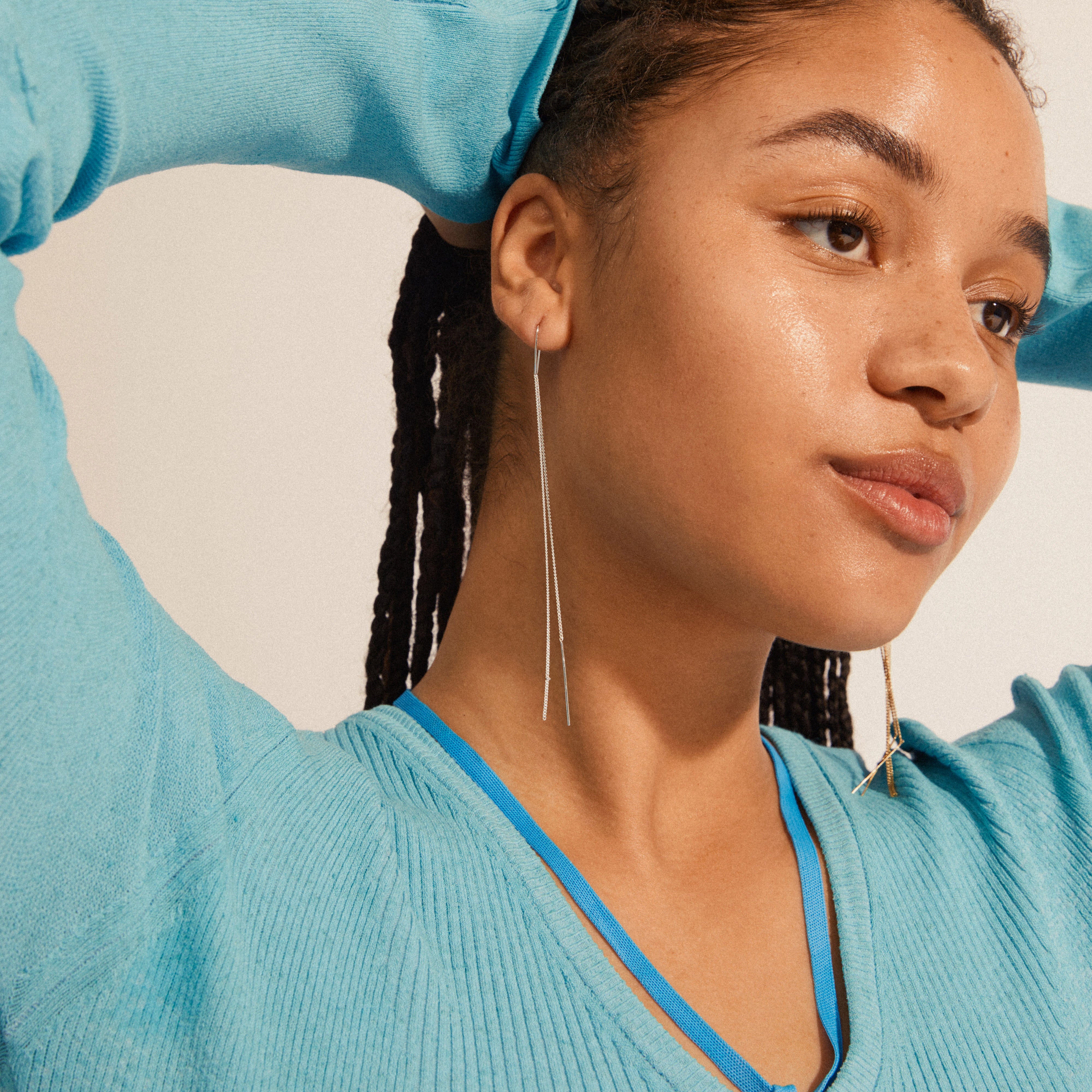Woman wearing Pilgrim's ENCHANTMENT silver-plated chain earrings, featuring elongated minimalist design, with long chains perfect for any occasion.