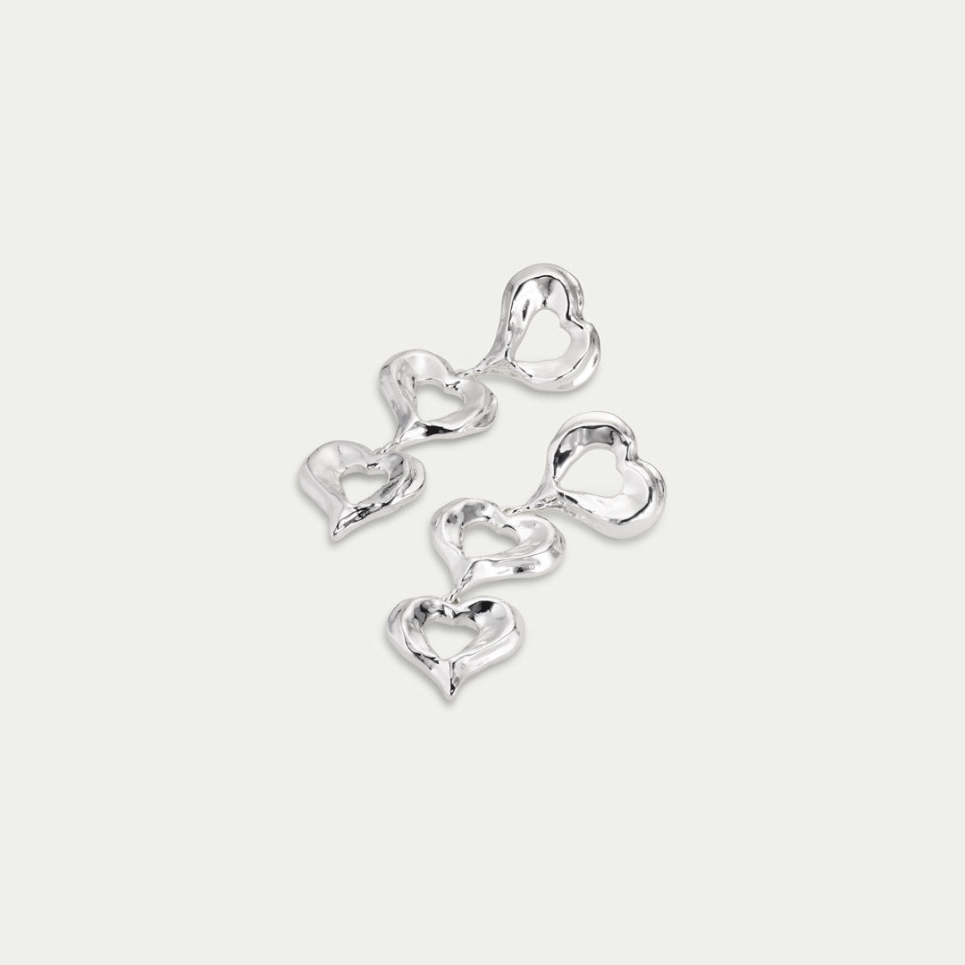 Silver-plated TIDE earrings featuring organically shaped hearts, exemplifying Pilgrim's blend of timeless and trendy Scandinavian jewelry.