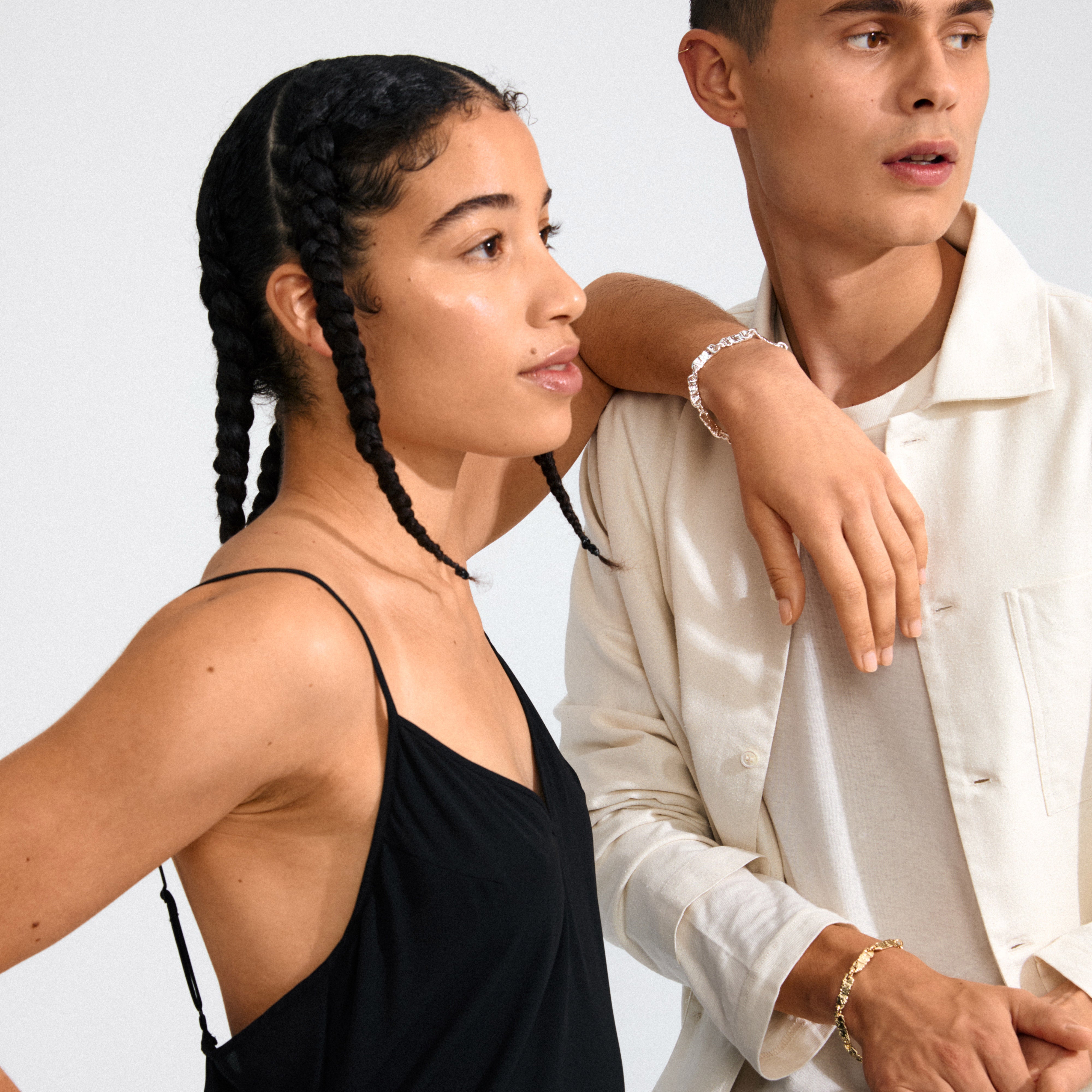 Models showcasing the INSTANT bracelet silver-plated by Pilgrim, featuring flat rectangular links and a raw, light-reflecting texture for a chic, effortless style.