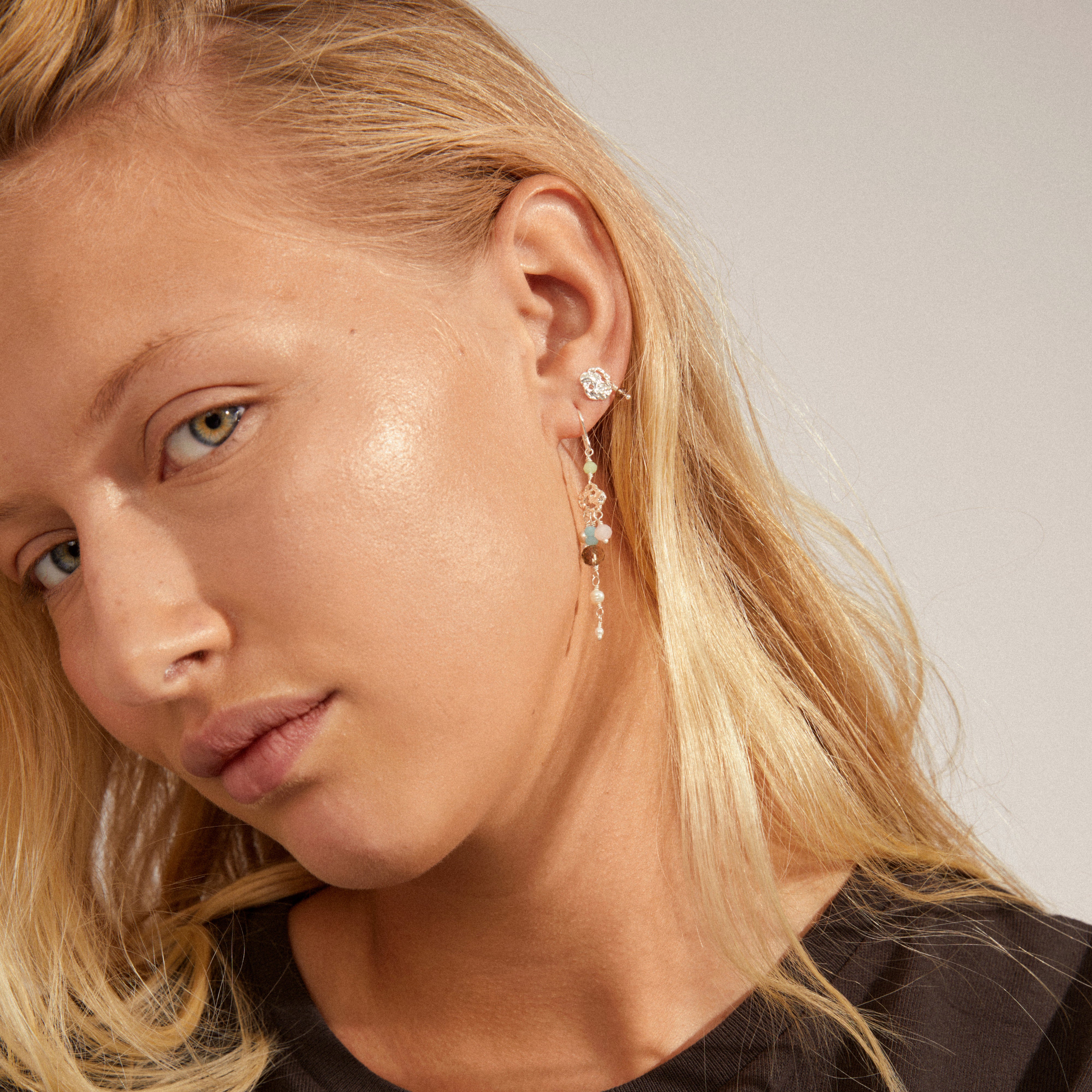 SMILE earrings 2-in-1 set silver-plated featuring colorful pearl pendants and asymmetrical hooks, worn by a woman with blonde hair, showcasing Pilgrim's boho style.