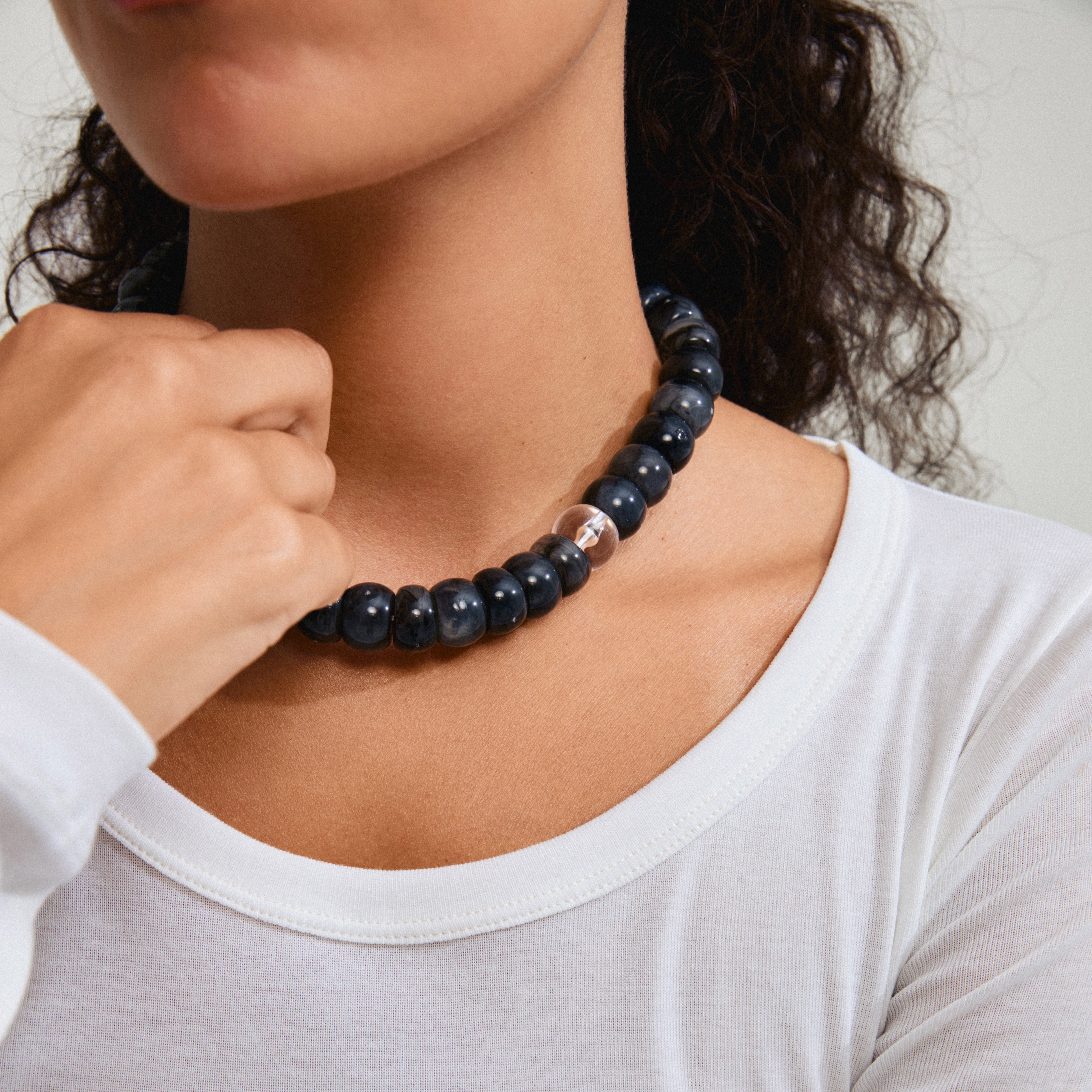 ECLIPSE necklace grey/gold-plated showcased on a woman, featuring chunky dark grey recycled acrylic beads, embodying Pilgrim's trendy, inclusive style.
