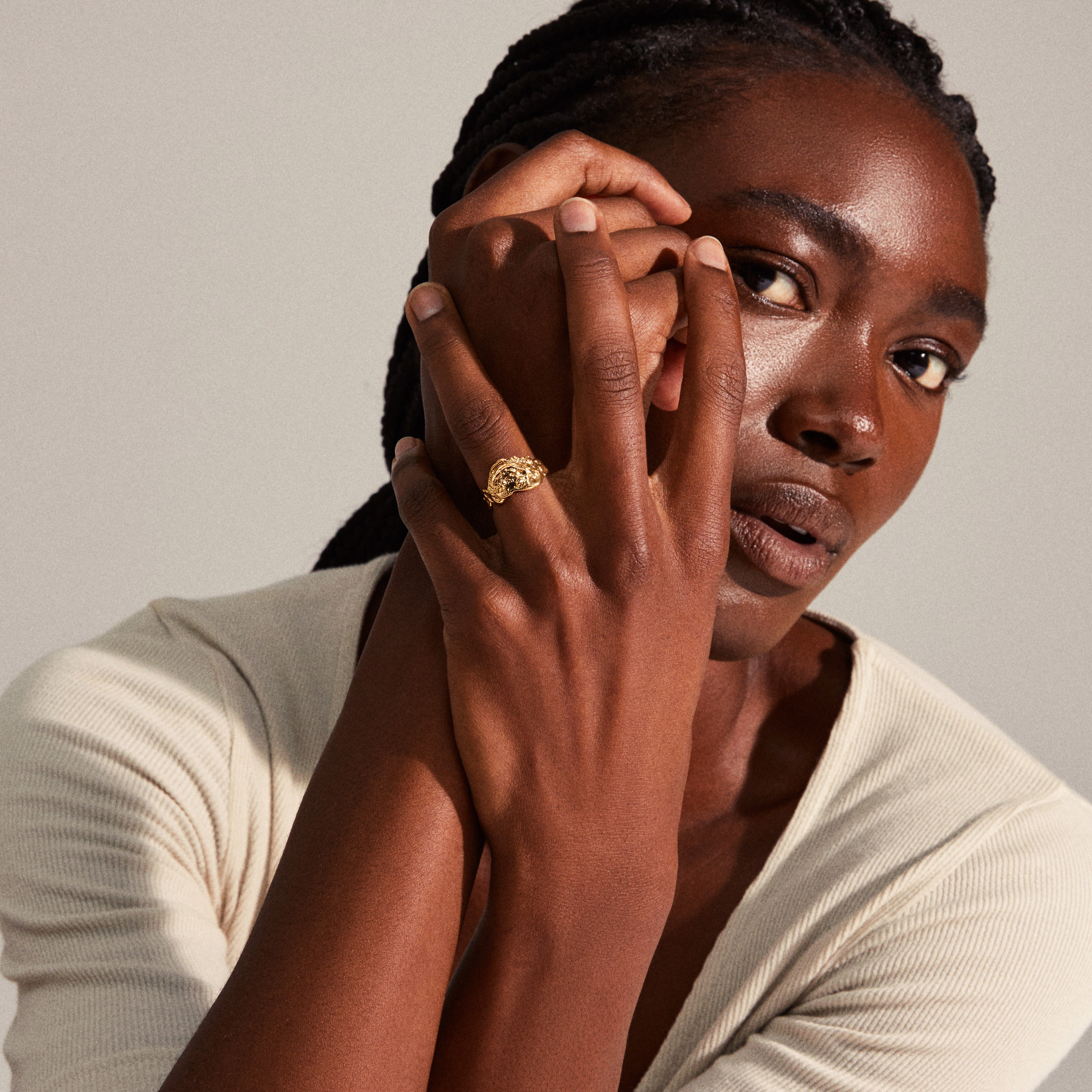Woman showcasing the BLOSSOM organic shaped gold-plated ring on her finger, highlighting its handcrafted, unfinished edges and unique silhouette from Pilgrim's Blossom collection.