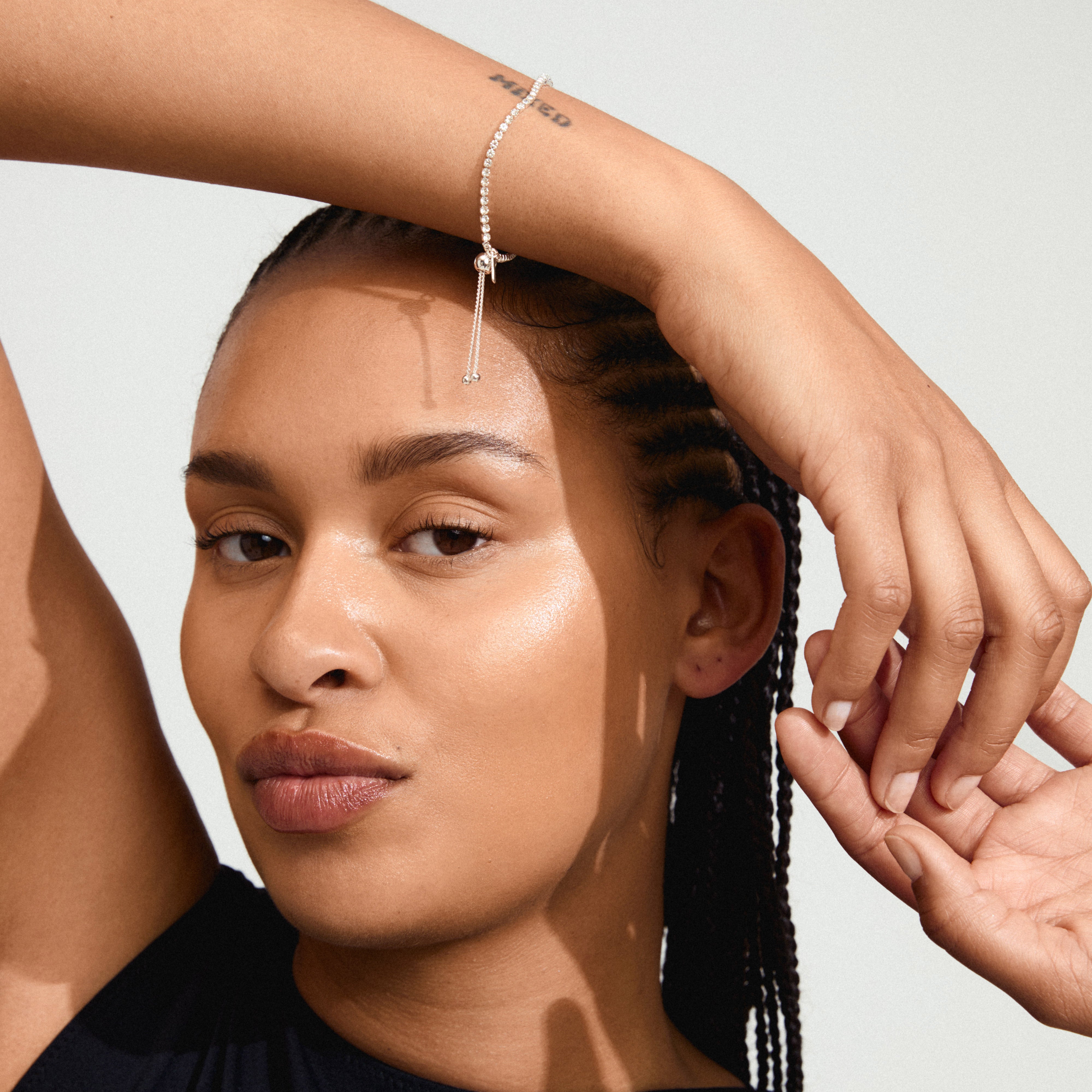 Woman showcasing the silver-plated SKY bracelet from Pilgrim, adorned with shiny Preciosa crystals and featuring an adjustable slide lock for a perfect fit.