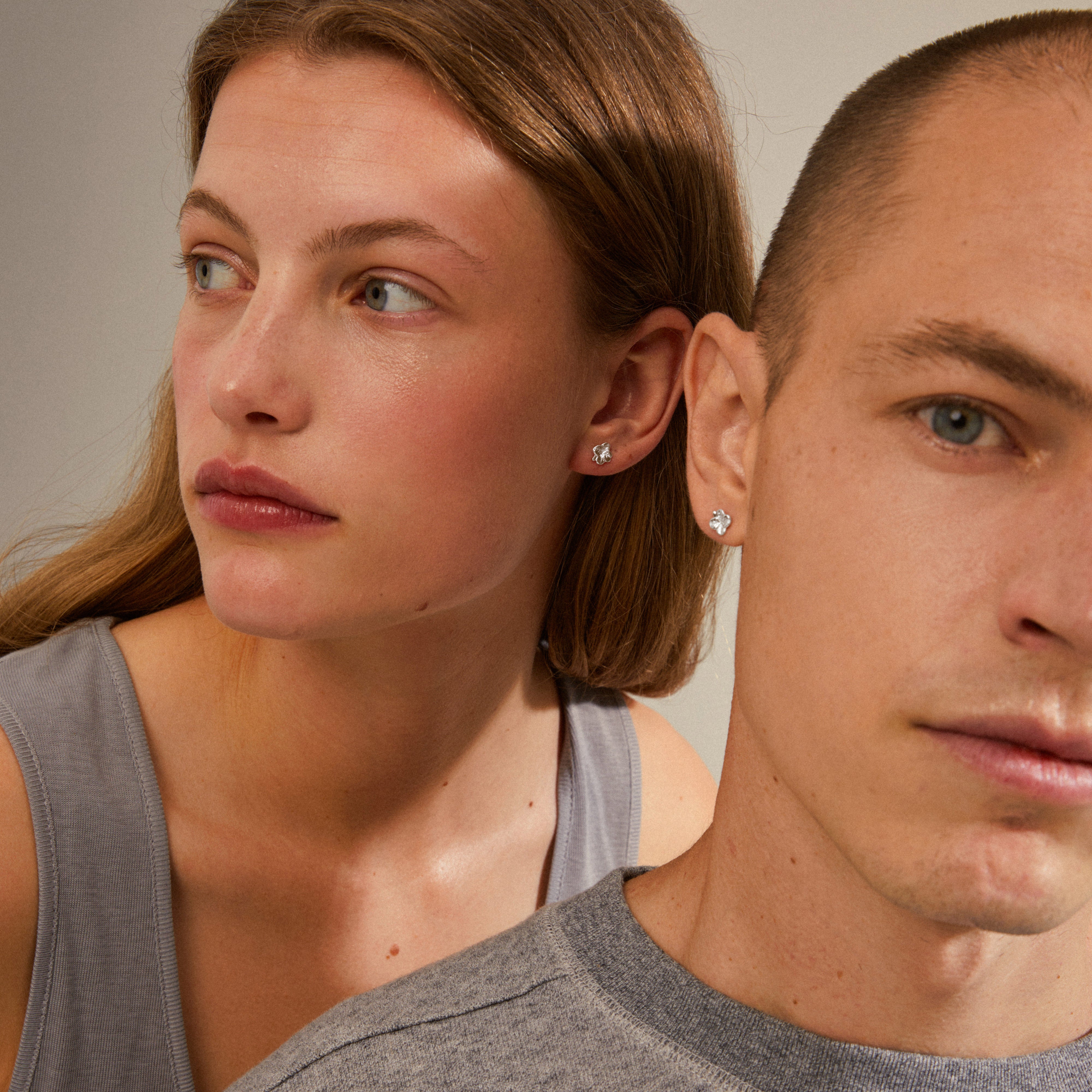 OCTAVIA clover earrings, silver-plated, showcased on a woman's ear, exemplifying a discreet, trendy style with a focus on sustainability and Scandinavian craftsmanship.