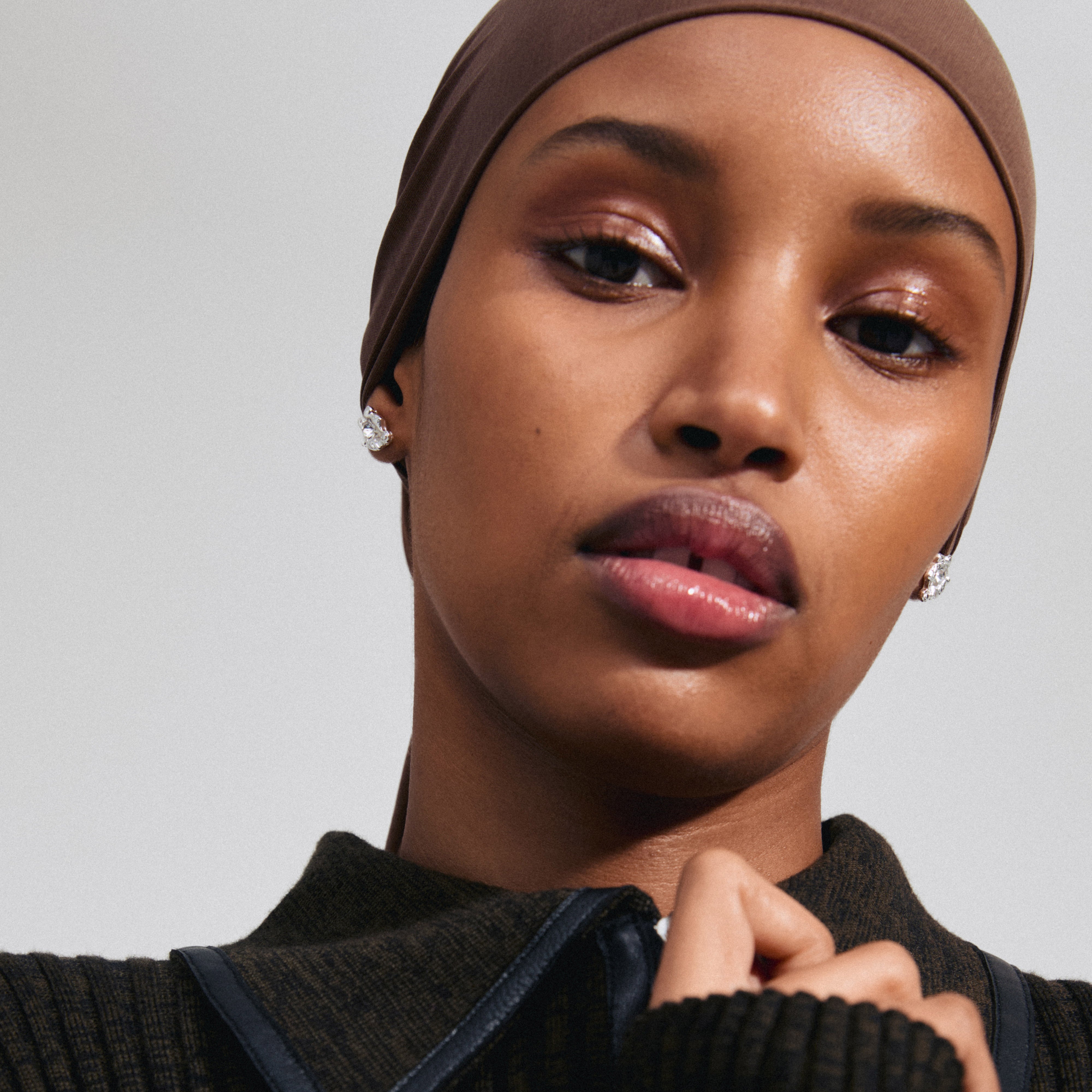AIAS silver-plated crystal earrings showcased on a woman with a headscarf, highlighting their sparkling Preciosa crystals and organic design.