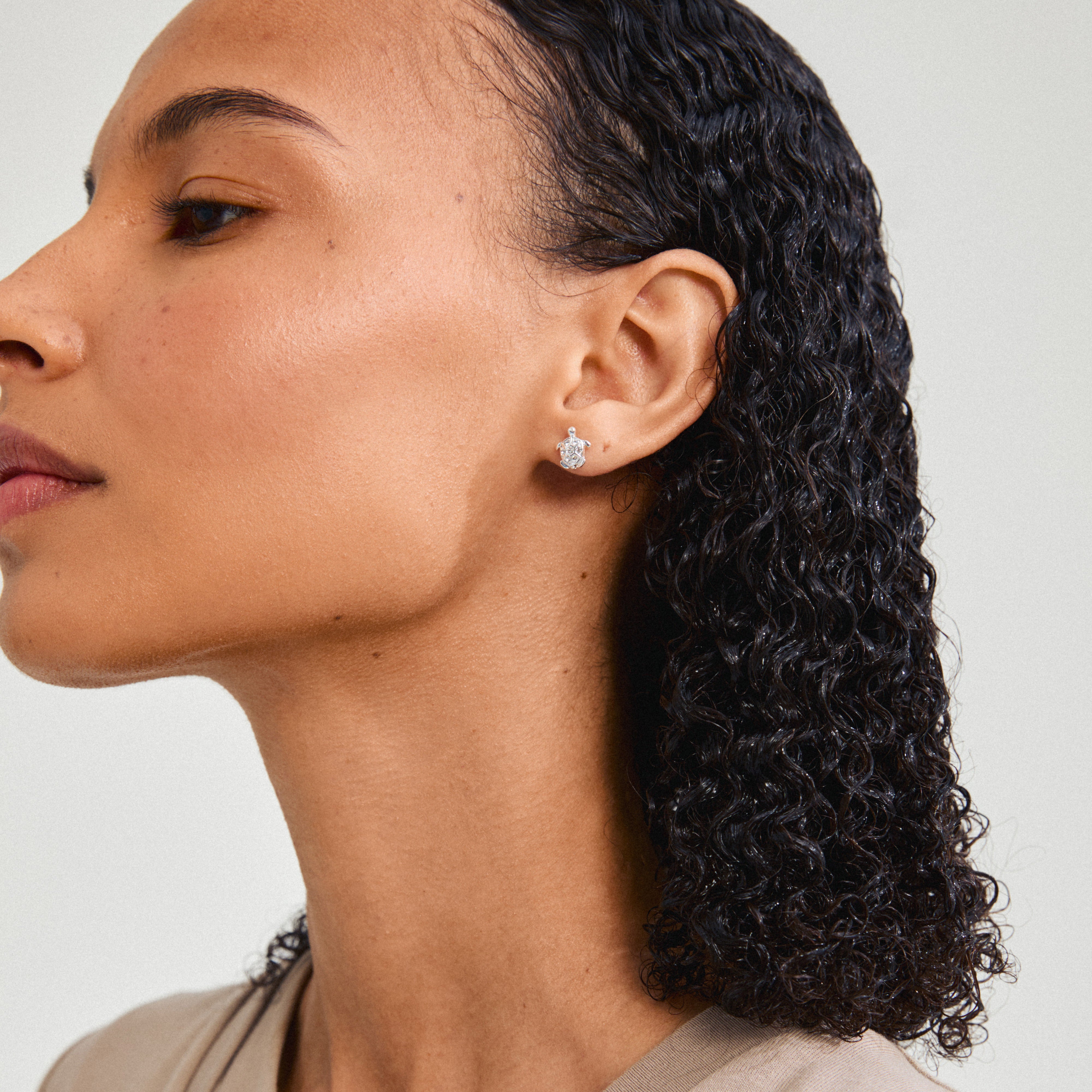 Silver-plated ARCHER earrings adorned with sparkling crystals and turtle charms, symbolizing fertility and longevity. Ideal for everyday wear, embodying Pilgrim's trendy, inclusive style.