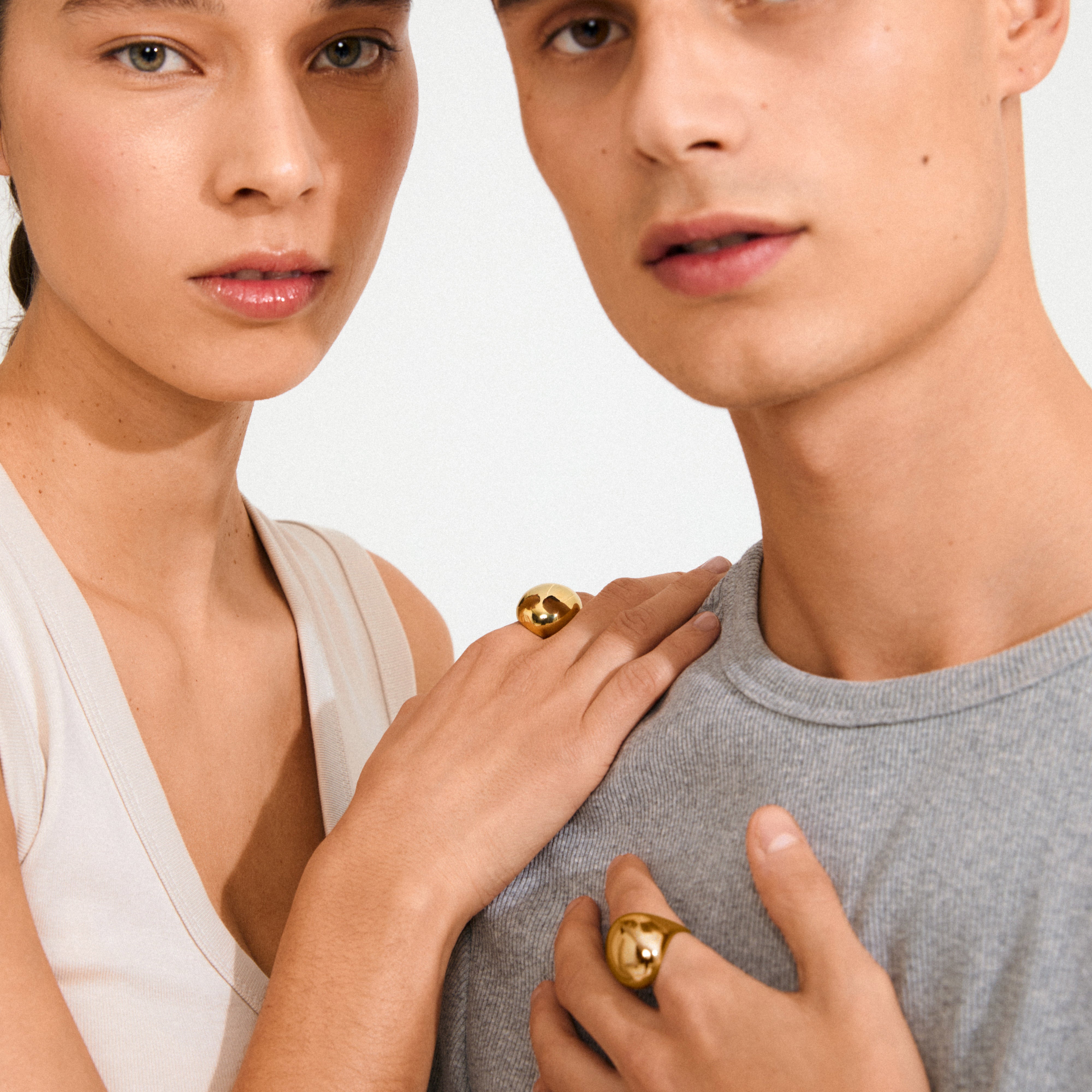 Two models showcase the gold-plated JAMESON ring, featuring a bubble dome design and chunky silhouette, highlighting its minimalist elegance and sustainable craftsmanship.