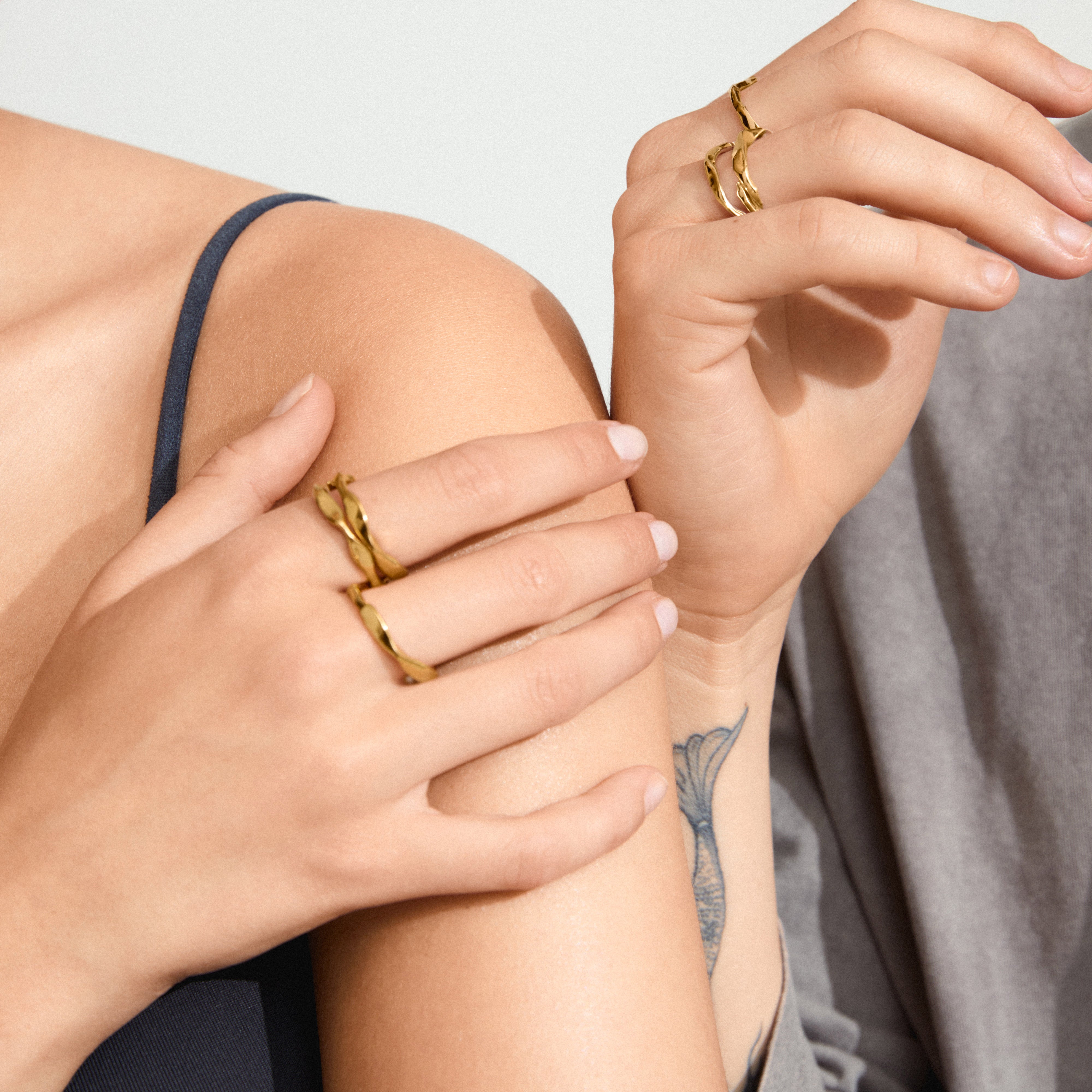 WYATT rings, 3-in-1 gold-plated set, showcased on a woman's hand with visible tattoos and jewelry, highlighting the adjustable, bold design from Pilgrim.