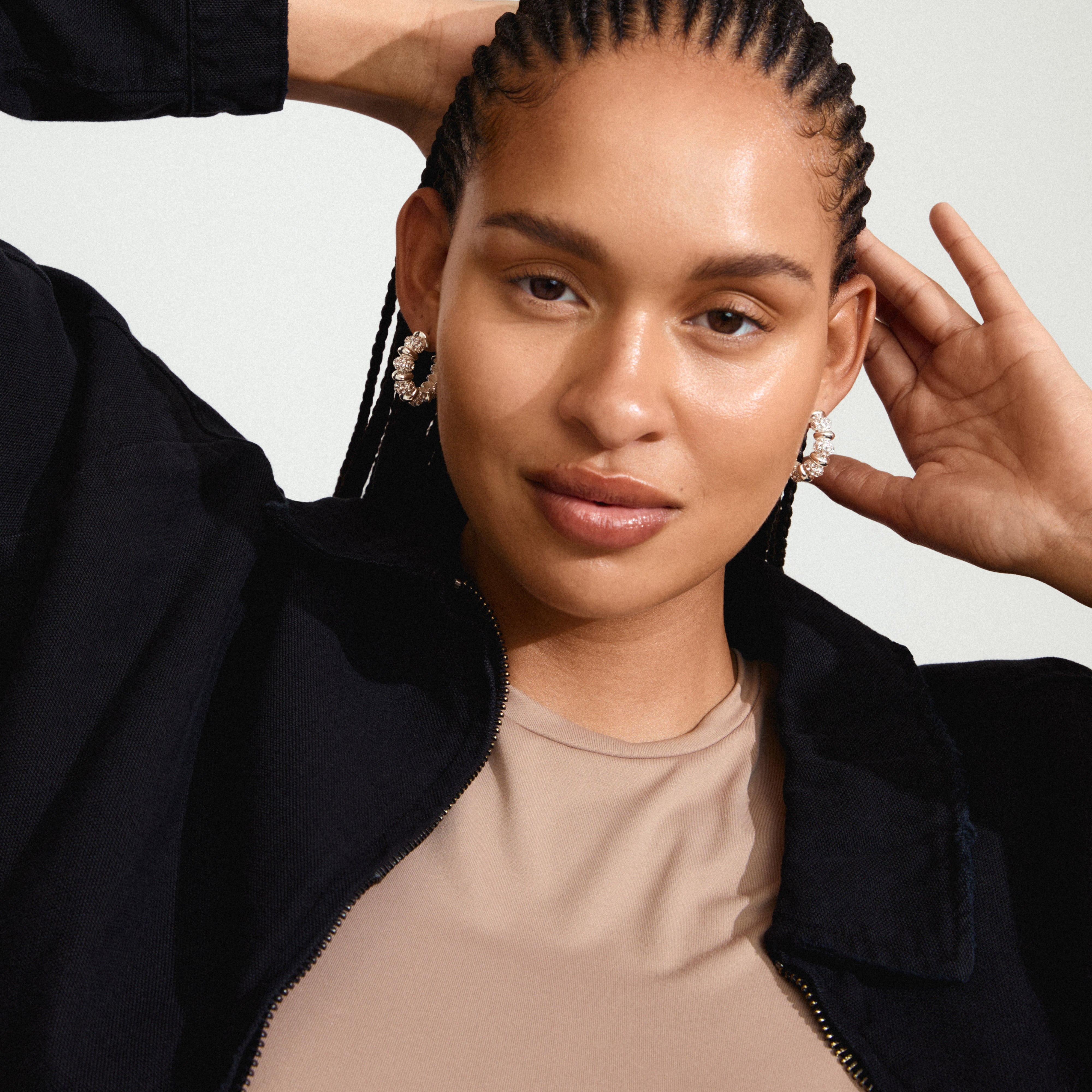 DELPHINE silver-plated earrings with vintage-inspired hoops and Preciosa crystals, worn by a woman with braided hair, offering a sparkling, stylish accessory.