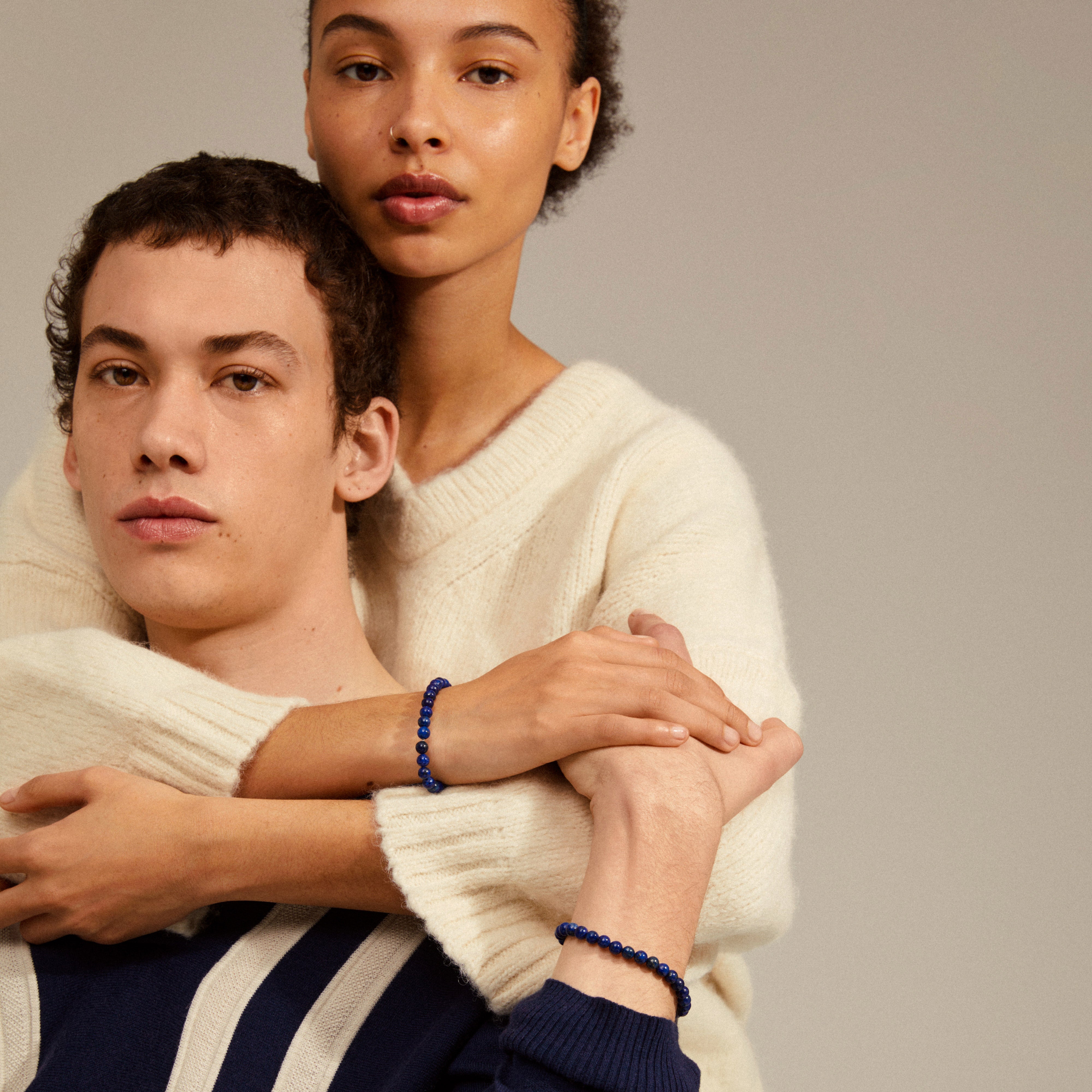 POWERSTONE bracelet featuring genuine lapis lazuli beads on durable elastic, showcased on a woman's wrist, symbolizing intuition and clarity. Perfect for personalized style layering.