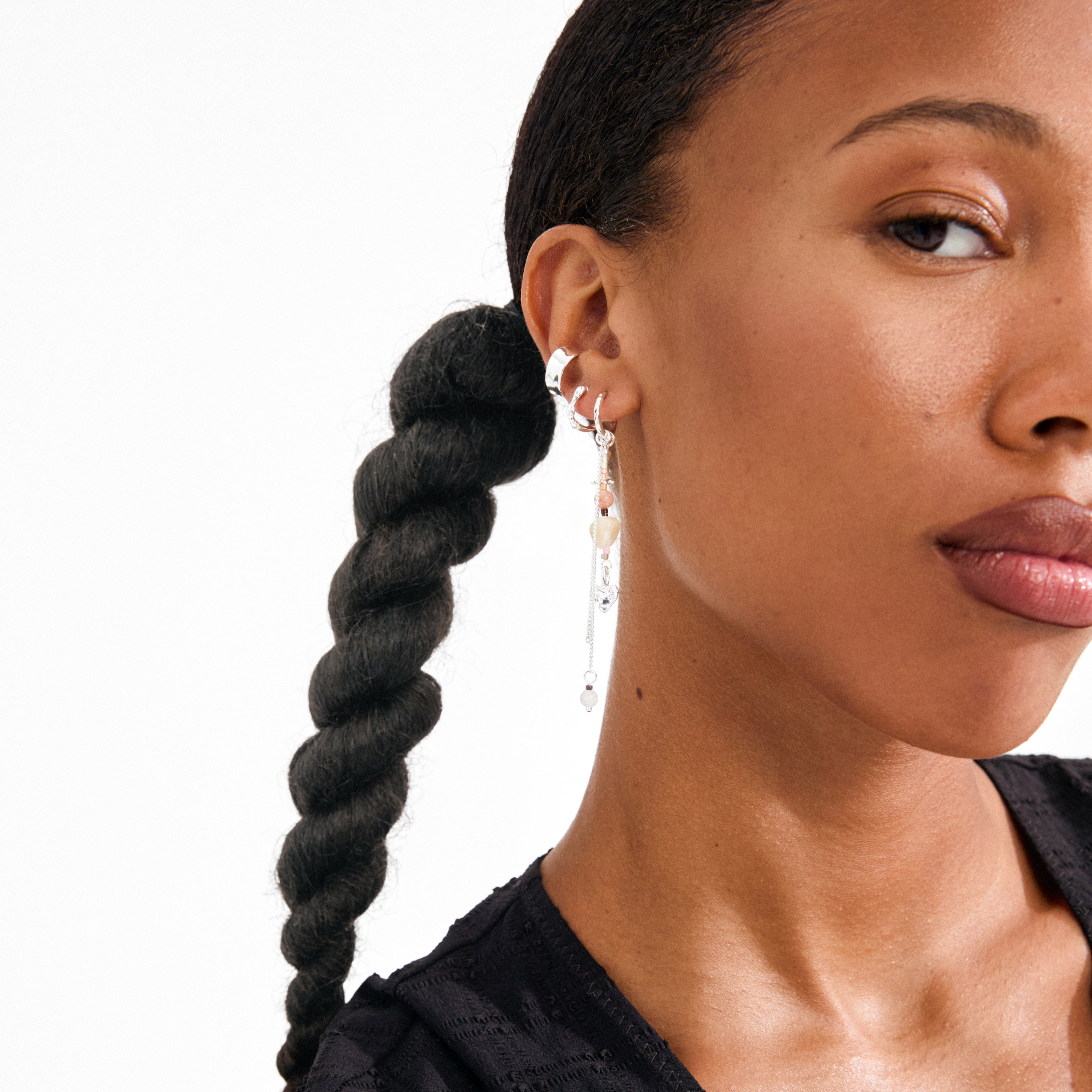 FINLEY single earring silver-plated with dangling chains and beads, worn by woman with braided hair and multiple silver hoop cuffs.