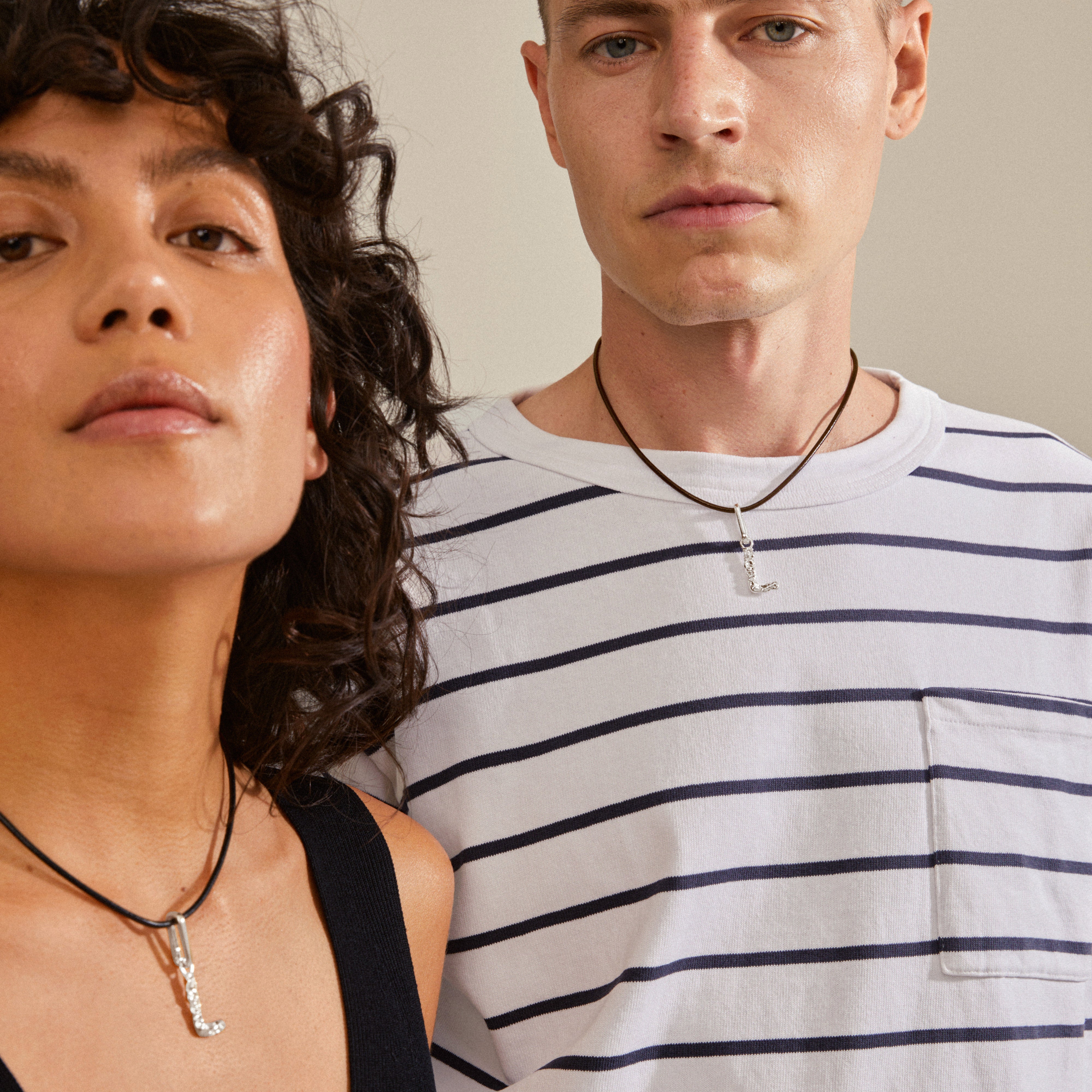 Silver-plated CHARM pendant L on a necklace, showcasing a rustic, personalized style. Part of Pilgrim's eco-friendly collection, made from 99% recycled materials.