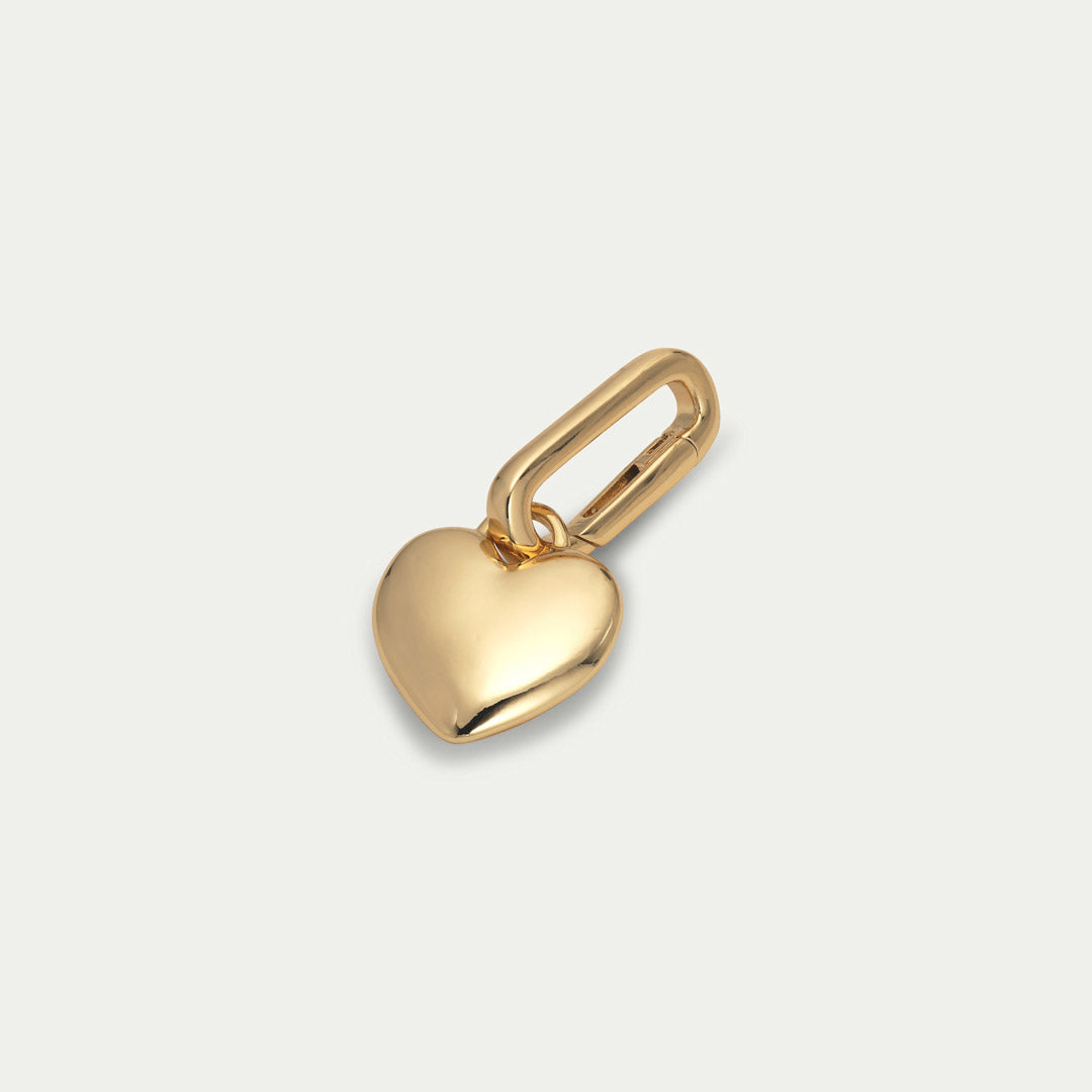 Gold-plated CHARM heart pendant by Pilgrim, perfect for personalizing with a chunky chain or hoops. Made from 99% recycled materials for sustainable style.