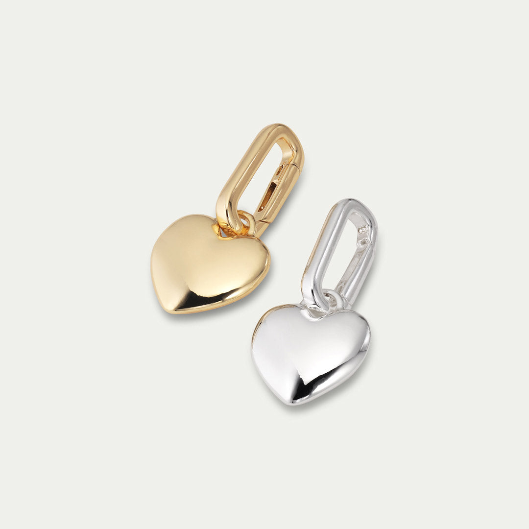 Gold-plated CHARM heart pendant by Pilgrim, designed for personal styling. Features shiny finish, ideal for adding to chains or hoops. Made from 99% recycled material.