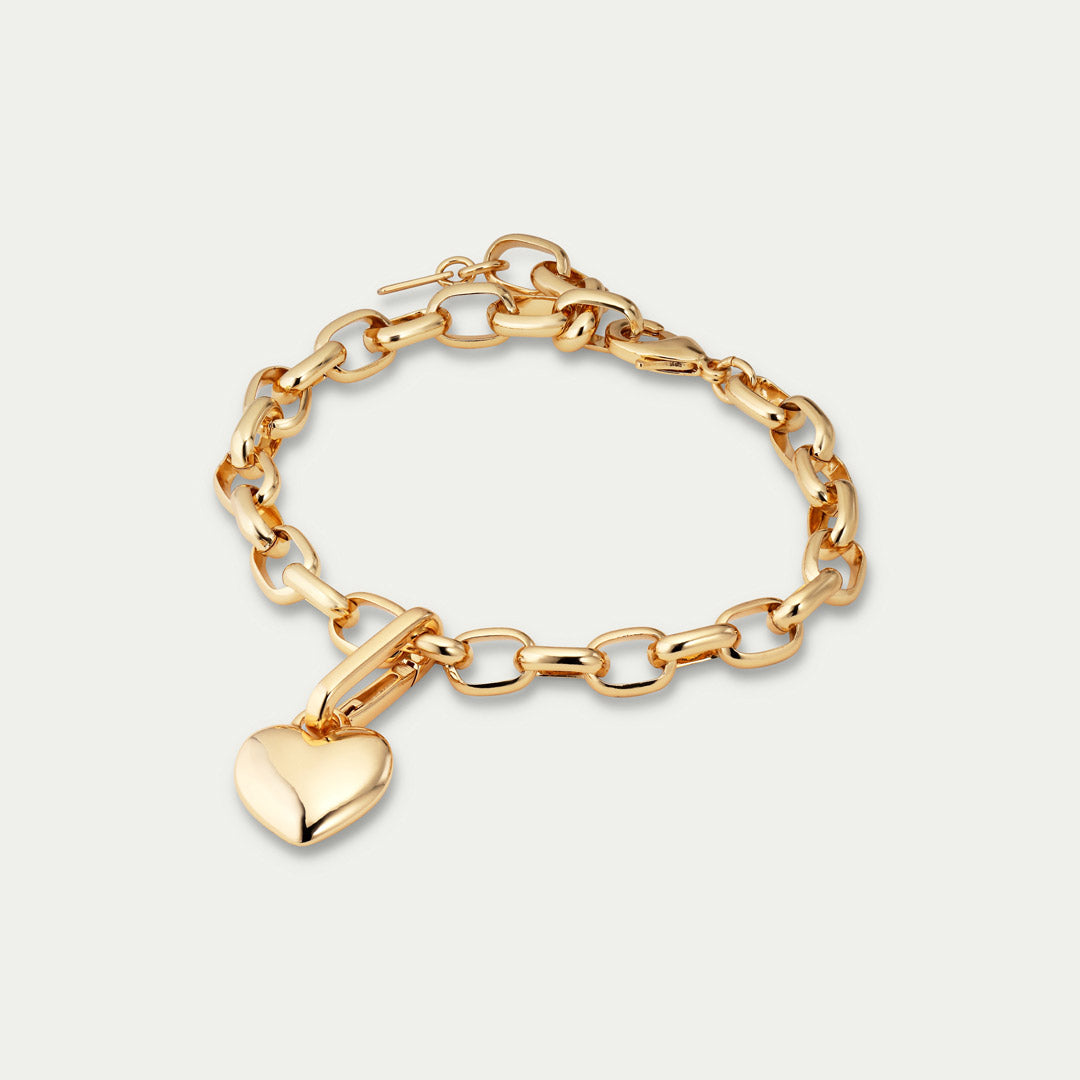 Gold-plated CHARM heart pendant by Pilgrim, featuring a shiny heart charm for personalized styling, crafted from 99% recycled material. Ideal for creating unique, fashion-forward looks.