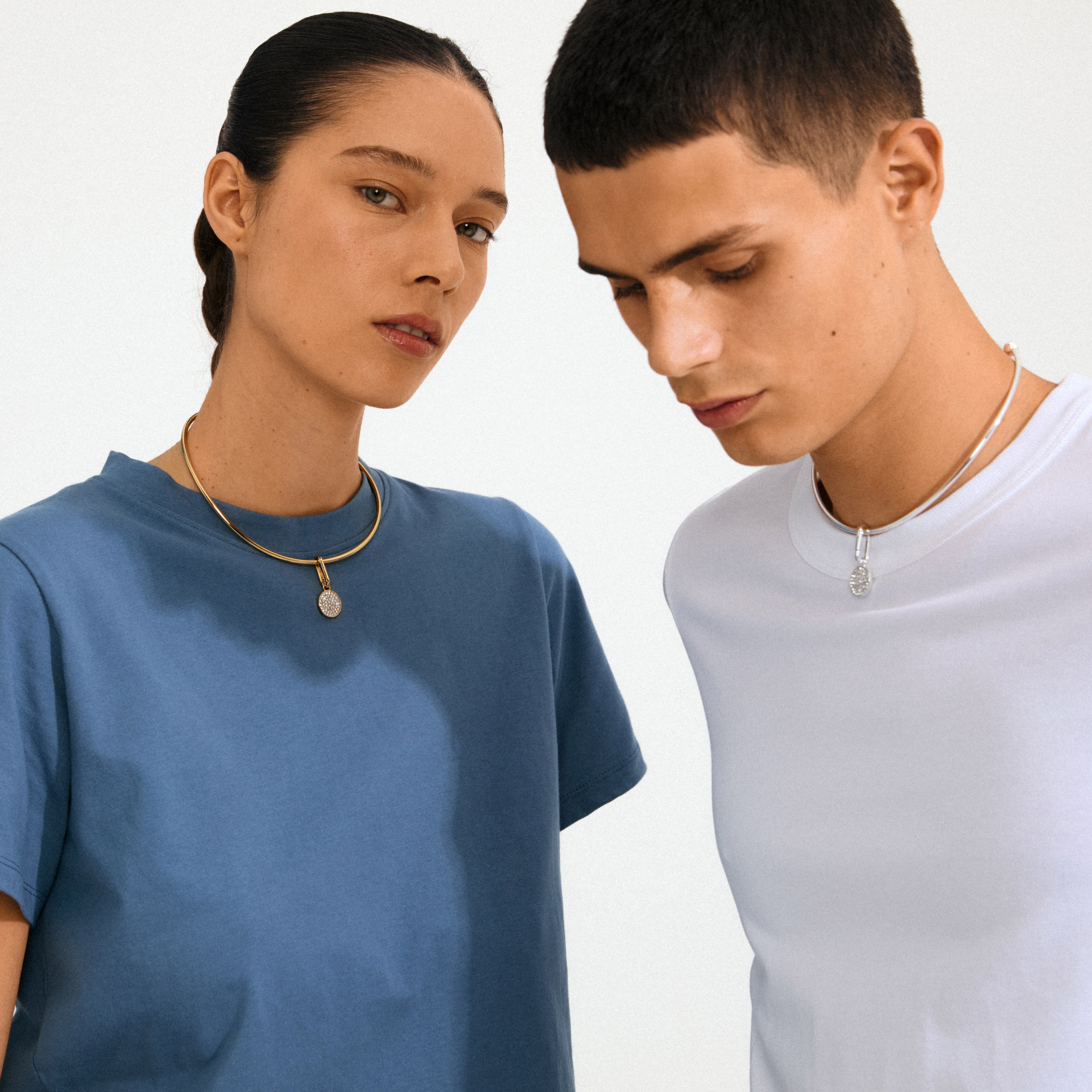 Models showcasing Pilgrim's CHARM crystal coin pendant in silver-plated choker style, featuring sparkling Preciosa crystals for a personalized, eco-friendly fashion statement.