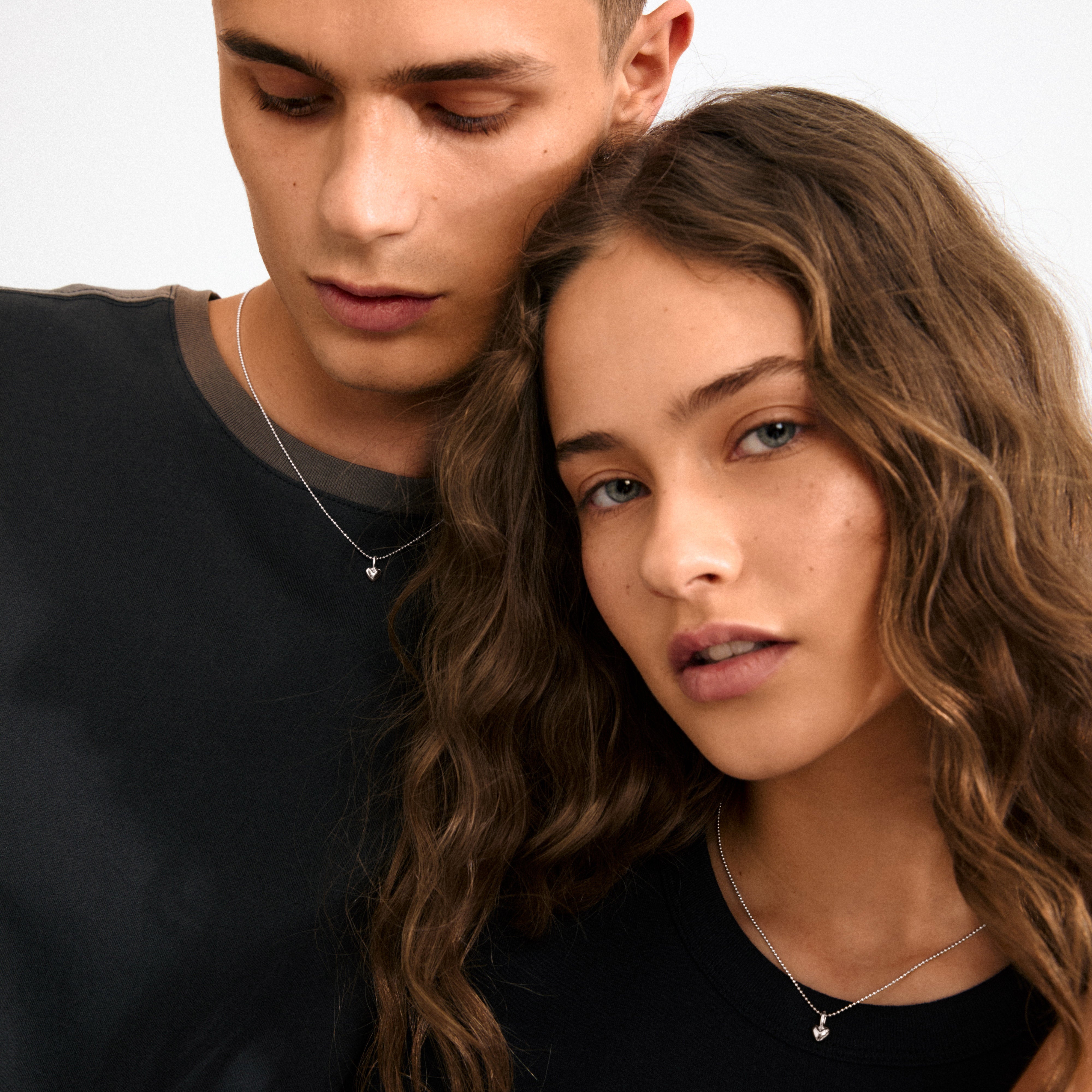 Silver-plated CHARM mini heart pendant, ideal for personal expression. Crafted from 99% recycled materials, perfect for minimalist styling or combining with other charms.