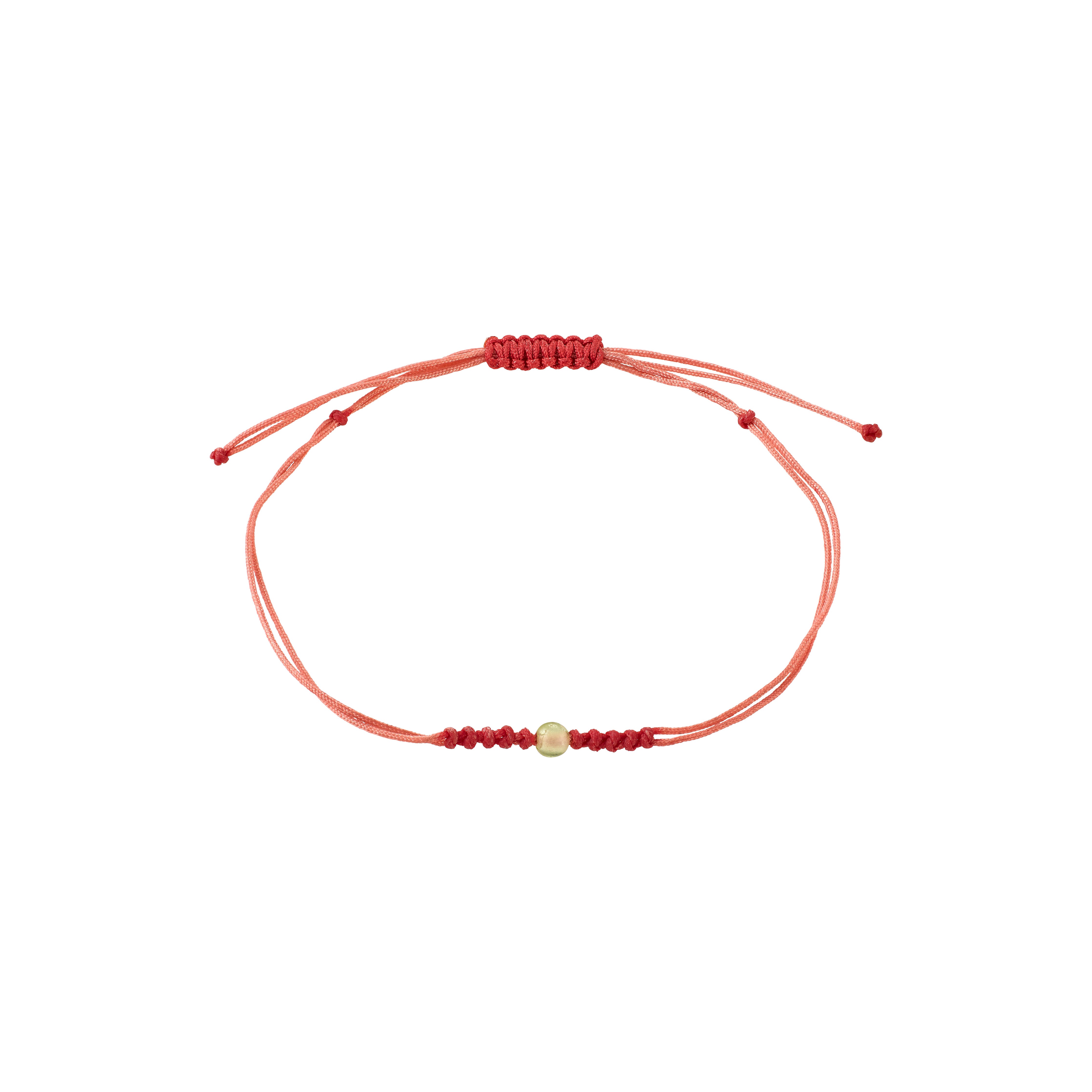 AUGUST birthstone bracelet featuring a red cotton cord with a gold bead and Peridot stone, embodying luxe boho style and Scandinavian craftsmanship.