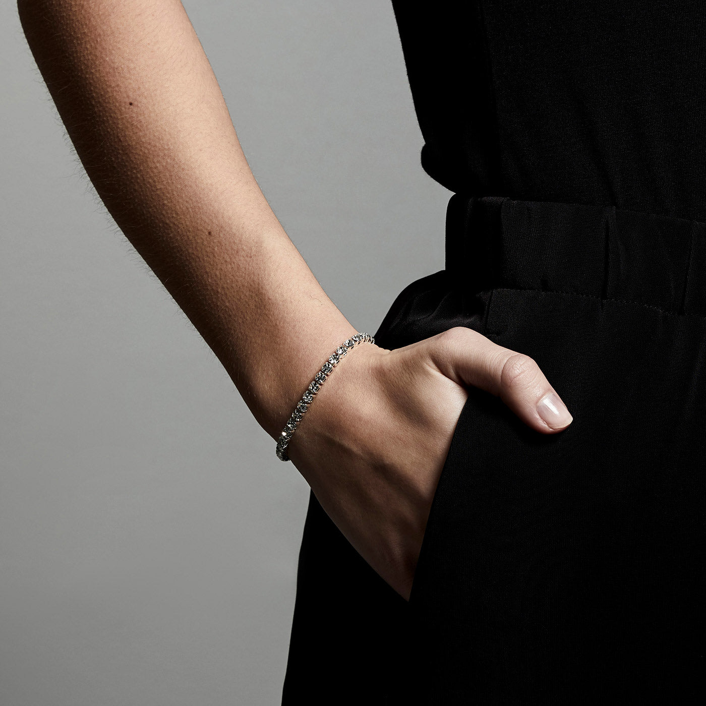 LUCIA crystal bracelet, silver-plated, worn on wrist, showcasing its adjustable, modern closure with sparkling crystal rows for an elegant, trendy look.