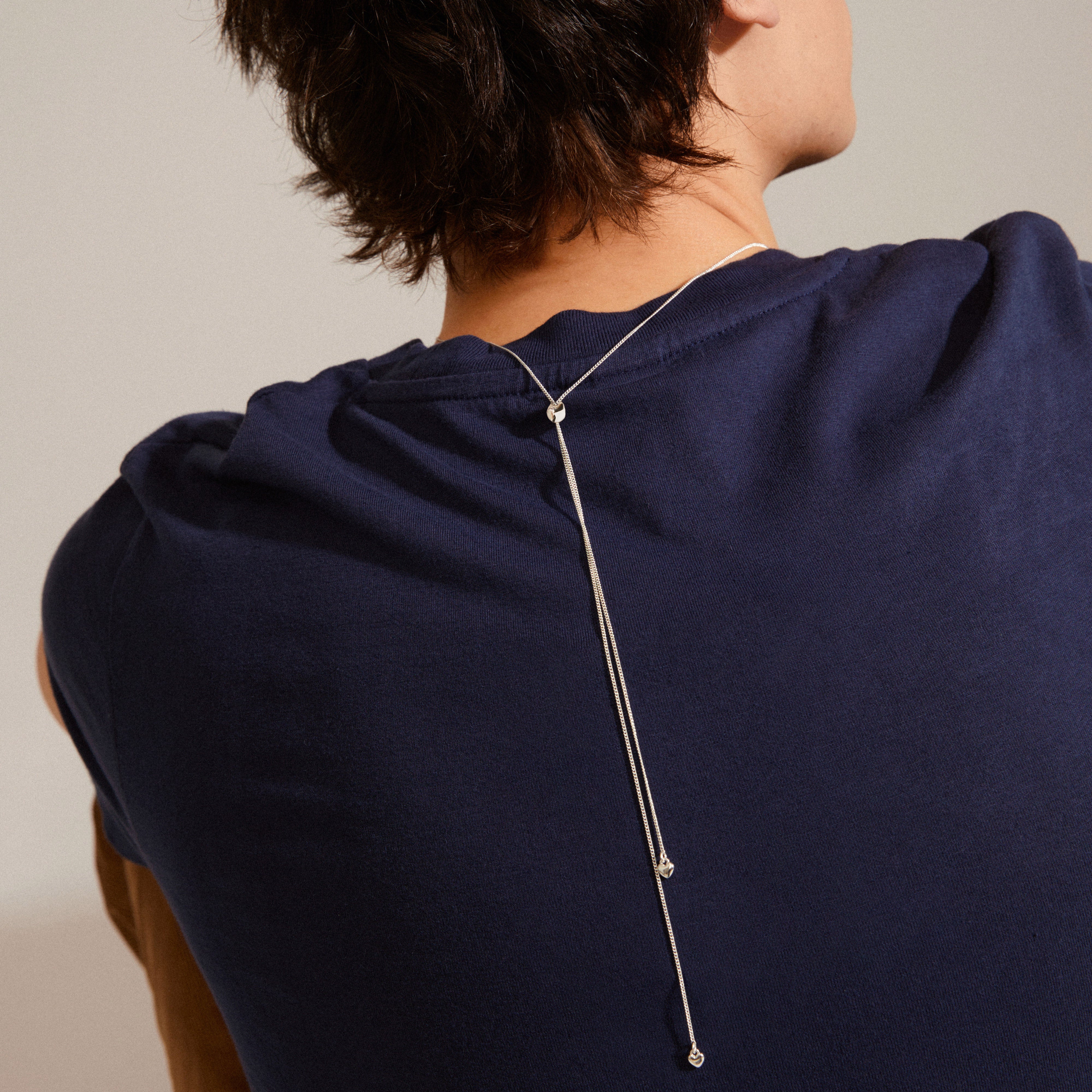 SOPHIA heart pendant necklace, silver-plated, worn by a person, showcasing its elegant, timeless design and adjustable length, perfect for a stylish and classic look.
