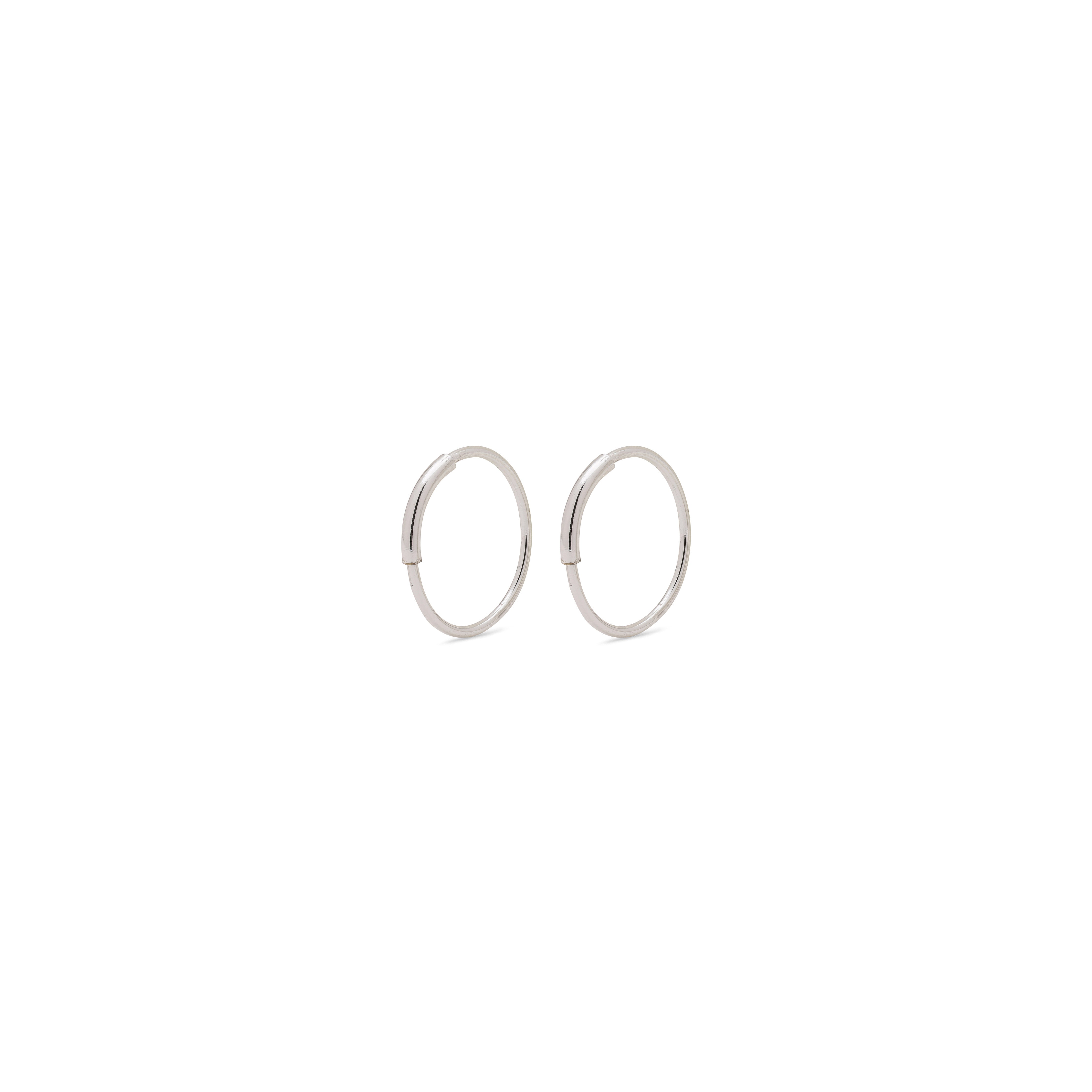 RAQUEL x-small silver-plated hoop earrings featuring minimalist design with an intriguing outer detail, ideal for versatile styling.