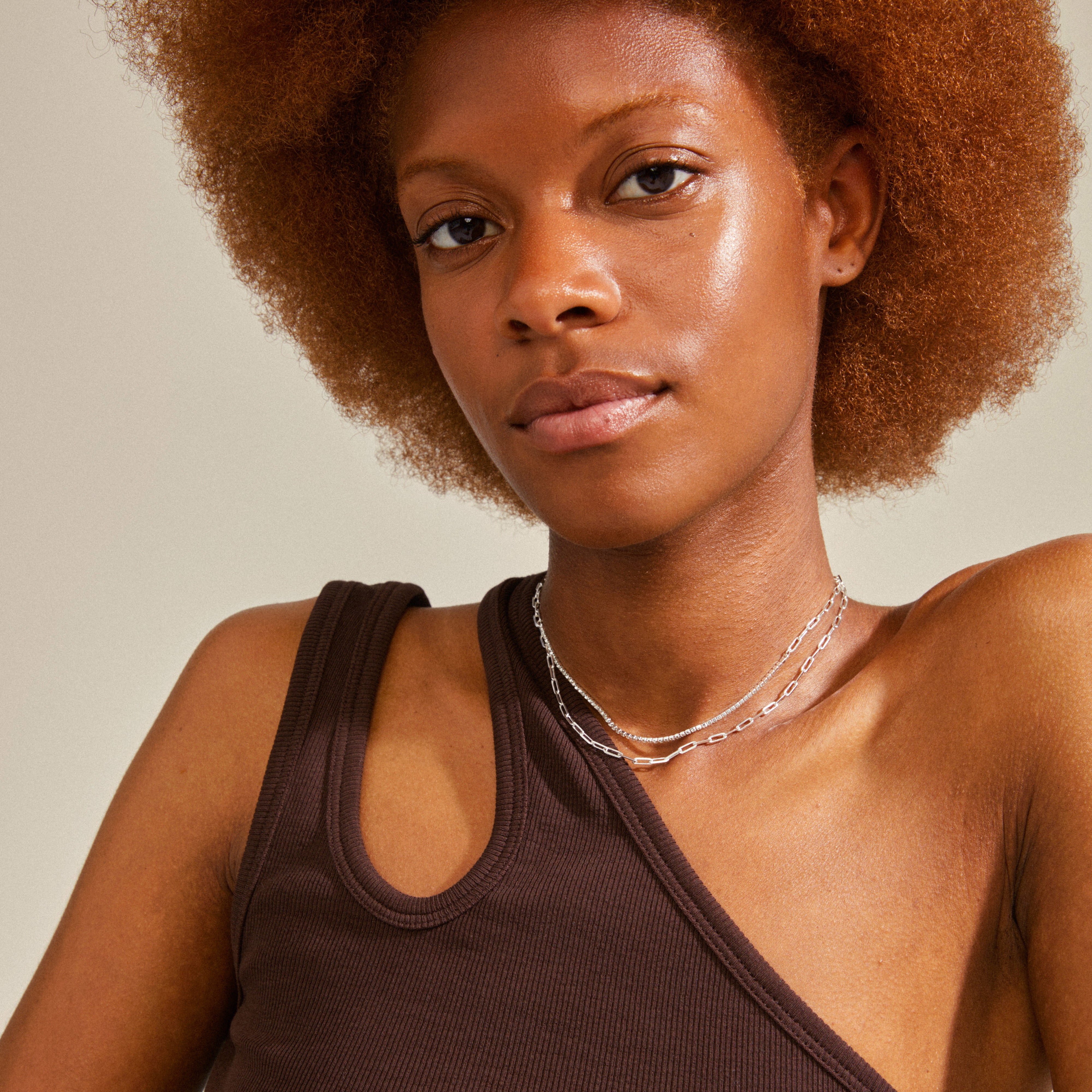 Woman wearing Pilgrim's ROWAN 2-in-1 silver-plated necklace with sparkling crystals and sleek cable chain, styled in a trendy layered look.