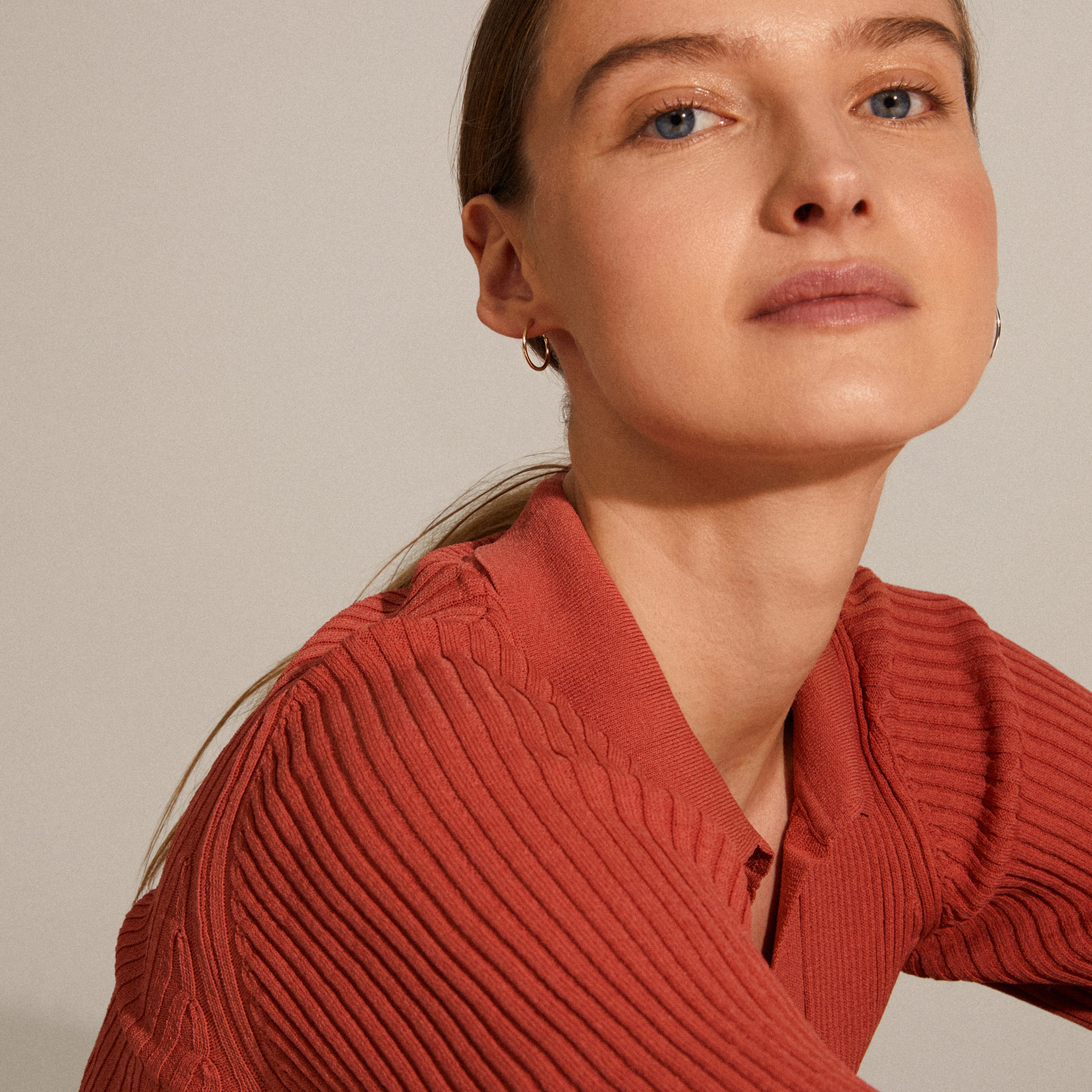 SANNE mini hoop earrings gold-plated worn by a woman, showcasing their elegant and classic design, perfect for any occasion.