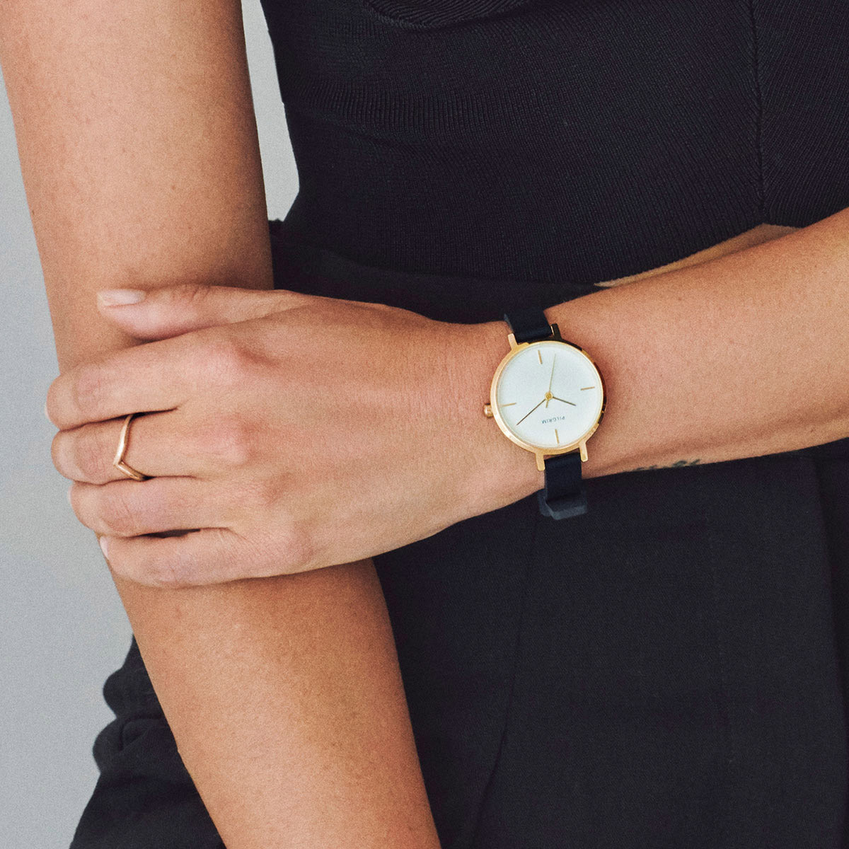 Close-up of a person wearing the LULU stack ring gold-plated from Pilgrim, showcasing its elegant design and stackable nature on the finger.