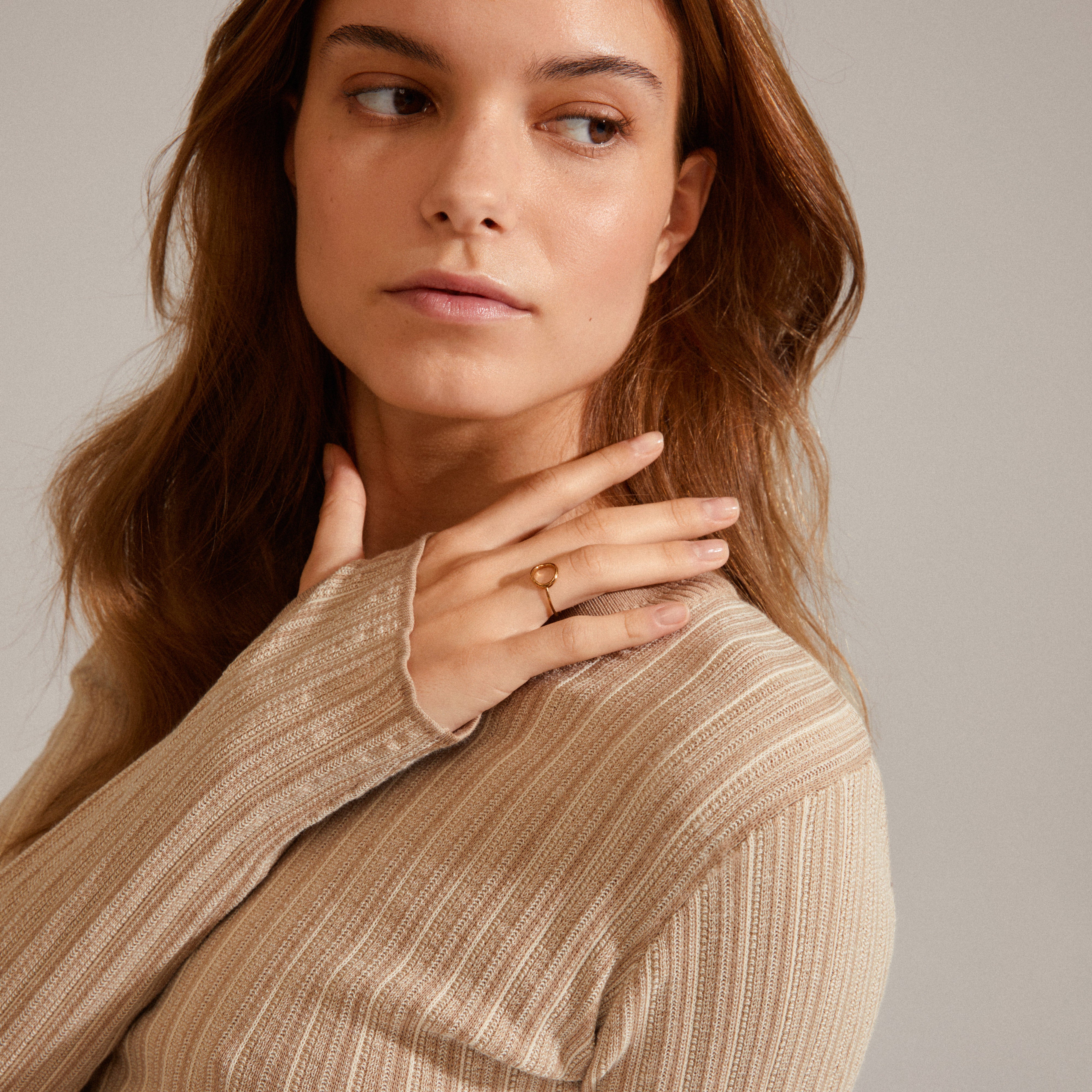 Gold-plated LULU stack ring showcased on a woman's hand, highlighting its intricate design and stackable versatility as part of Pilgrim's jewelry collection.