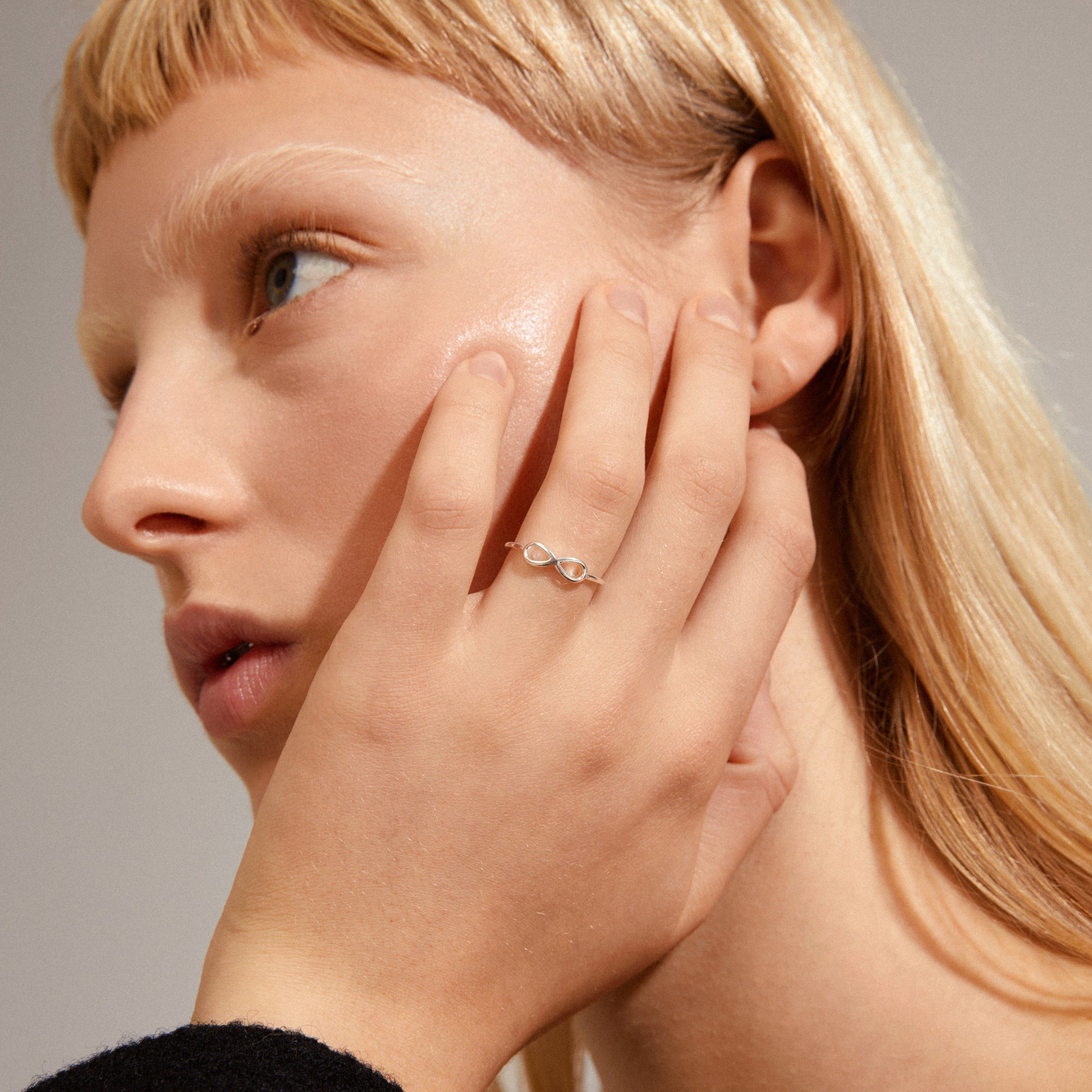 Silver-plated LULU eternity stack ring on a woman's hand, showcasing its elegant design from Pilgrim's symbolic stackable collection.