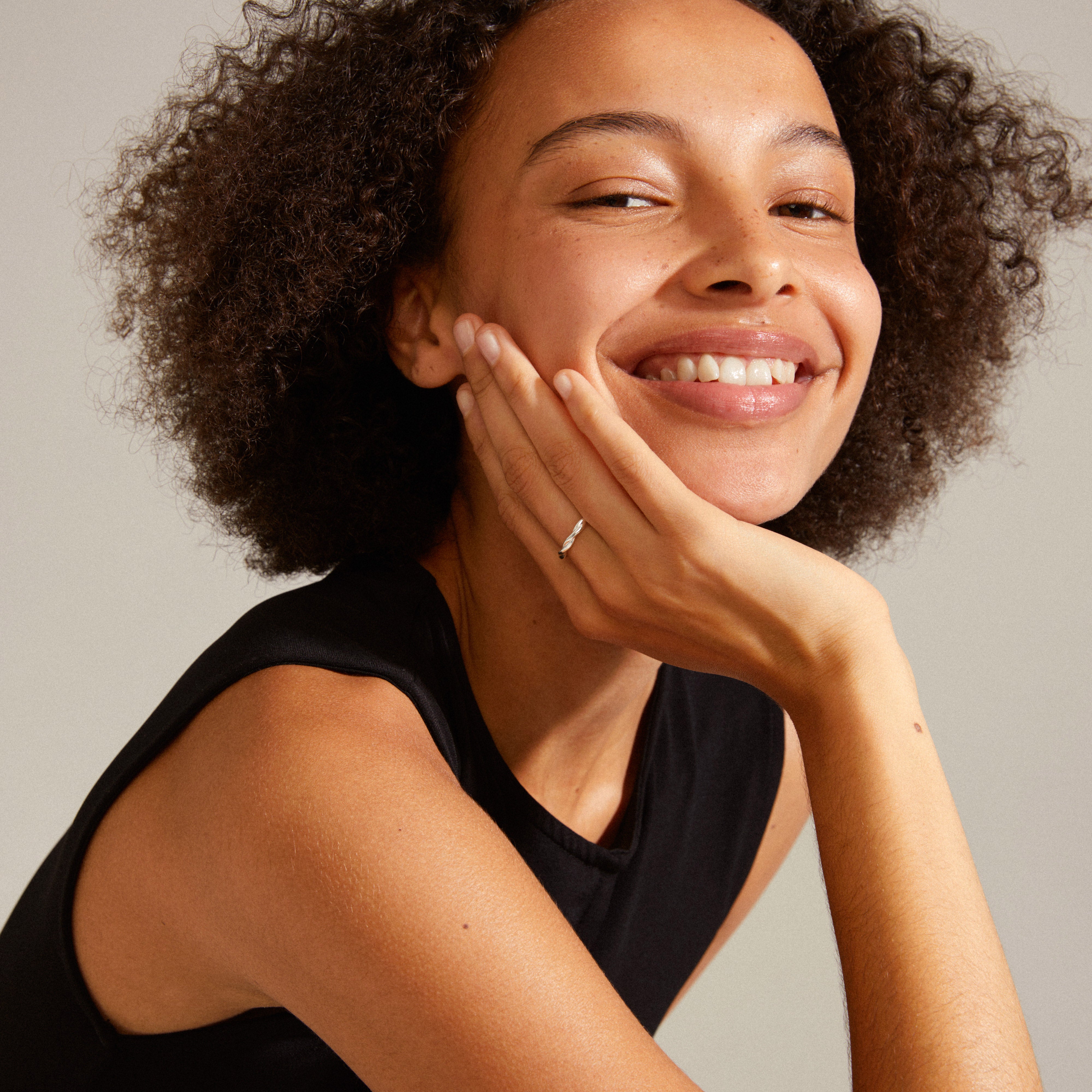 LULU twirl stack ring silver-plated worn by a smiling woman, showcasing its elegant design, ideal for trendy stacking with Pilgrim's stylish rings.