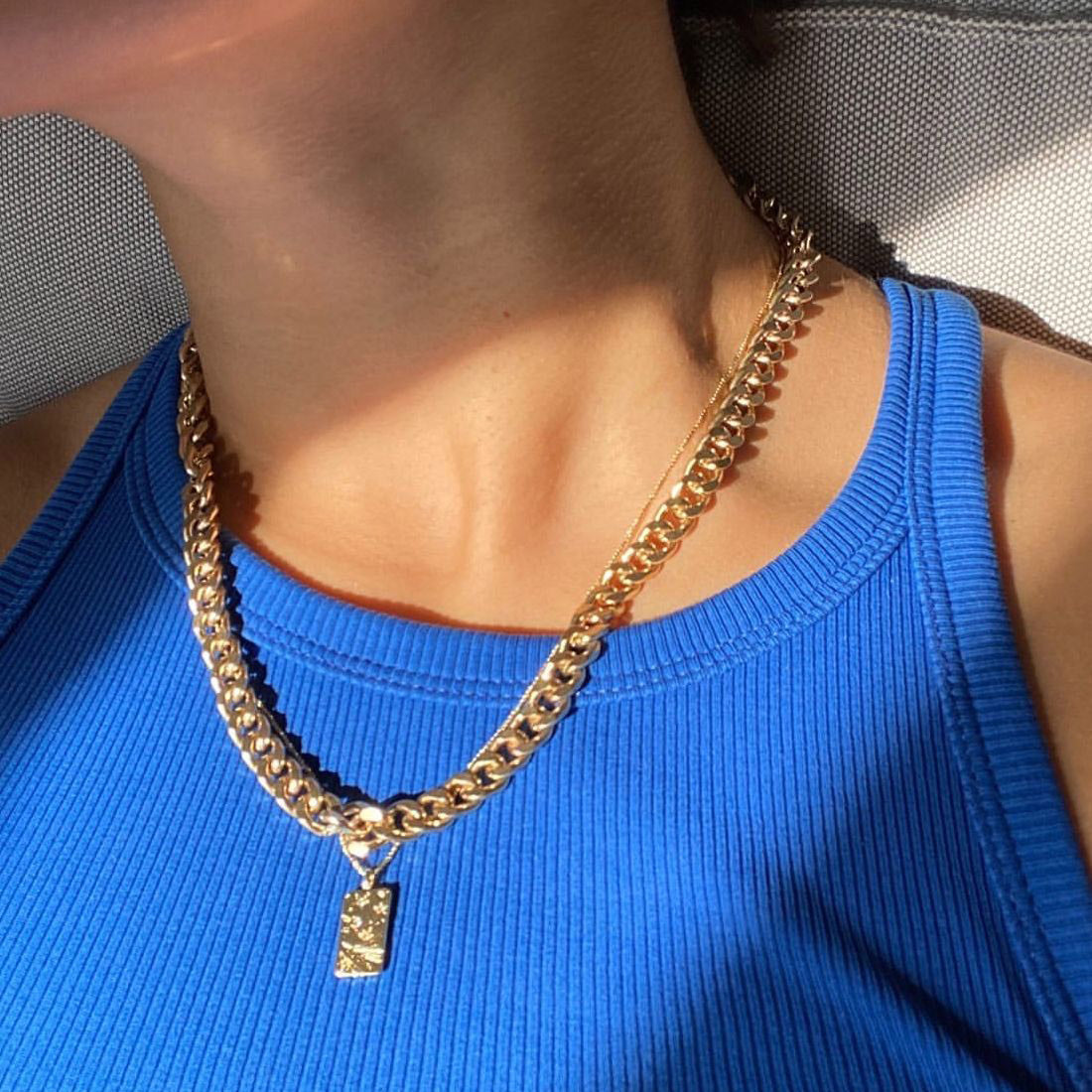 FUCHSIA curb chain necklace, gold-plated, worn by a person, showcasing its chunky, bold design from Pilgrim's Classic collection.