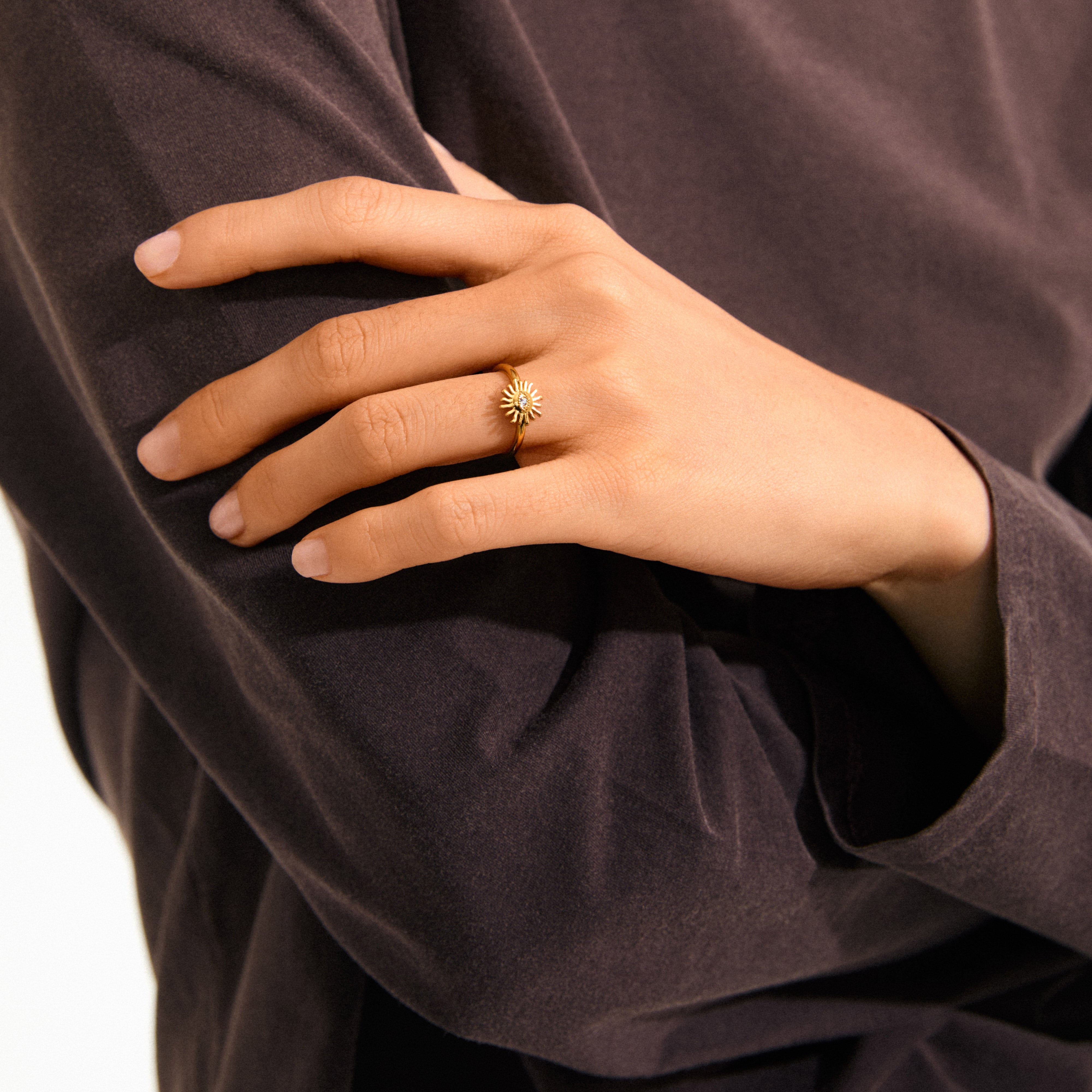 Gold-plated LULU sun stack ring featuring a sun design with a central eye and crystal, perfect for a unique, eco-friendly statement or stacking.