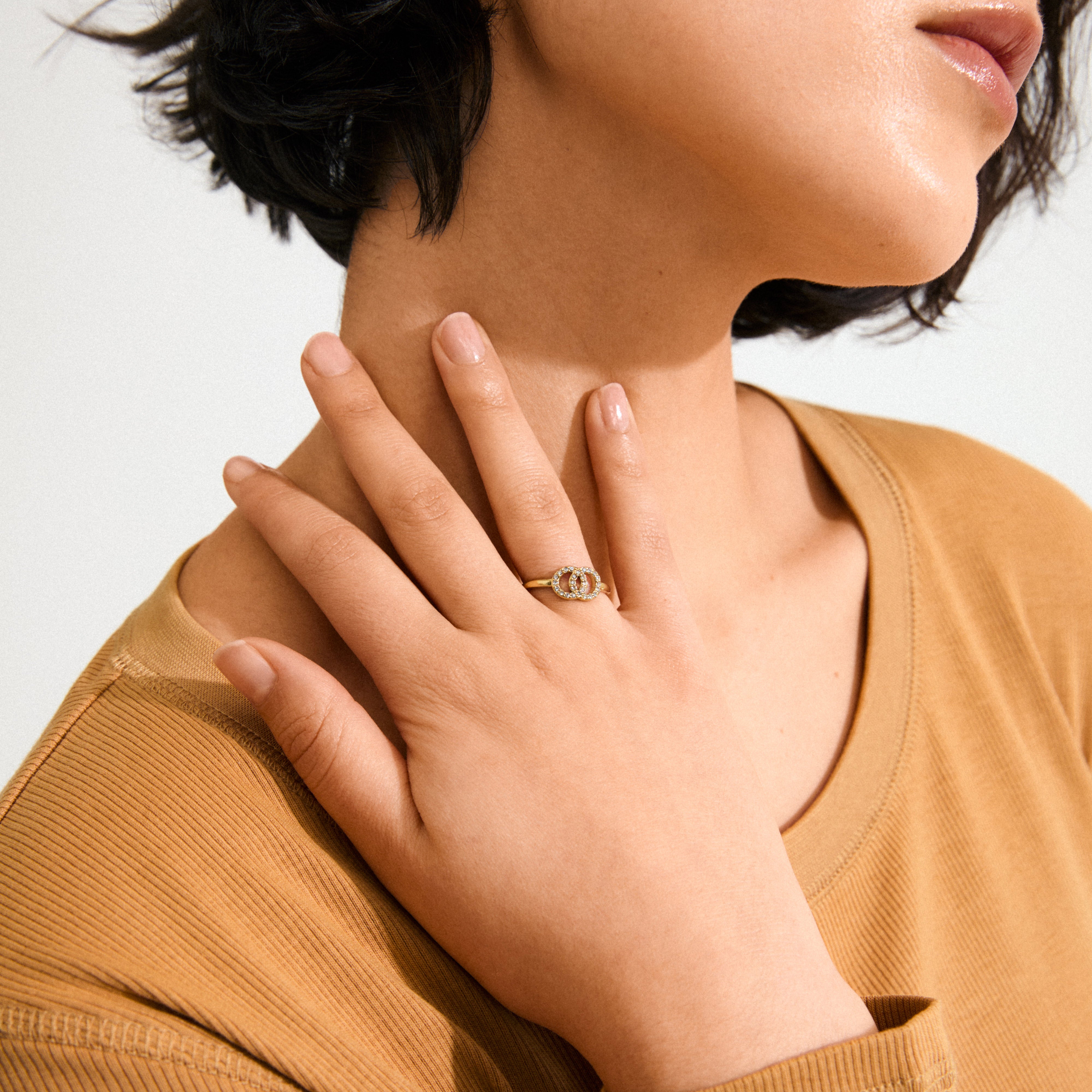 LULU halos stack ring gold-plated featuring two crystal-adorned circles, symbolizing connection and balance, crafted from 93% recycled material for a chic, eco-friendly look.
