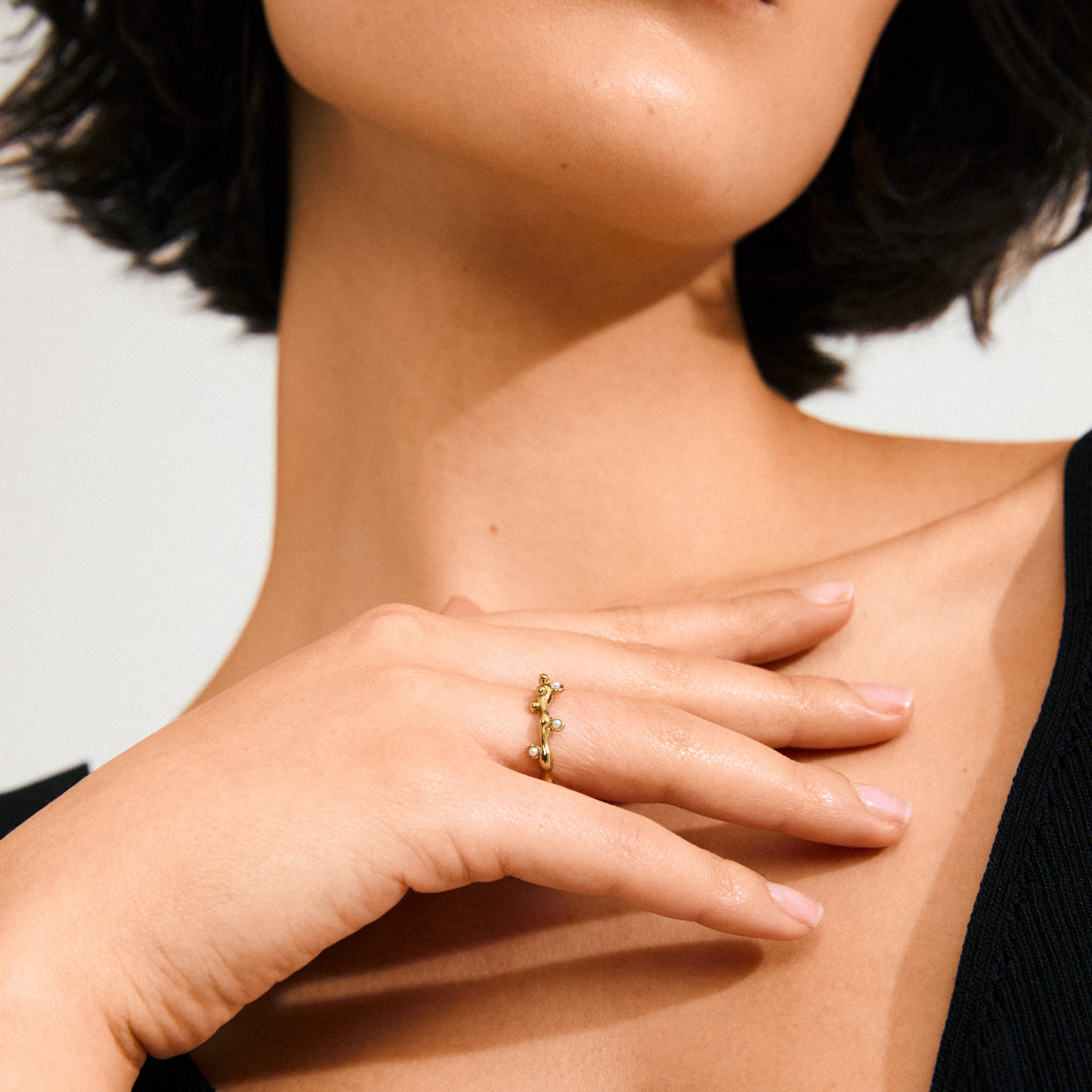 Gold-plated LULU magic stack ring with organic design, featuring mother-of-pearl beads like dewdrops, crafted from 98% recycled materials for an elegant, magical look.