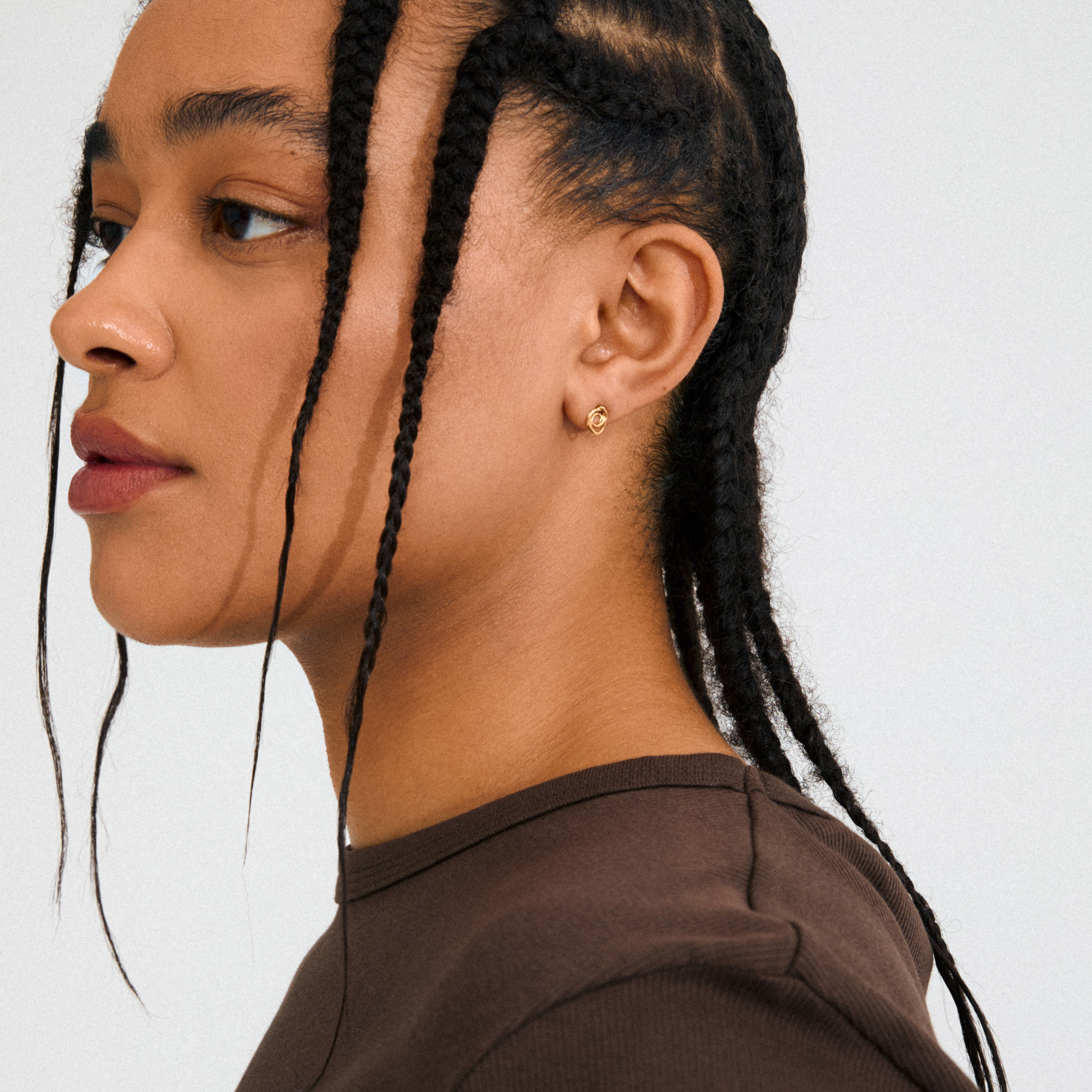 Gold-plated DIEGO earrings with a fluid doodle design, showcasing intricate details for a playful, creative statement, crafted from 99% recycled materials by Pilgrim.