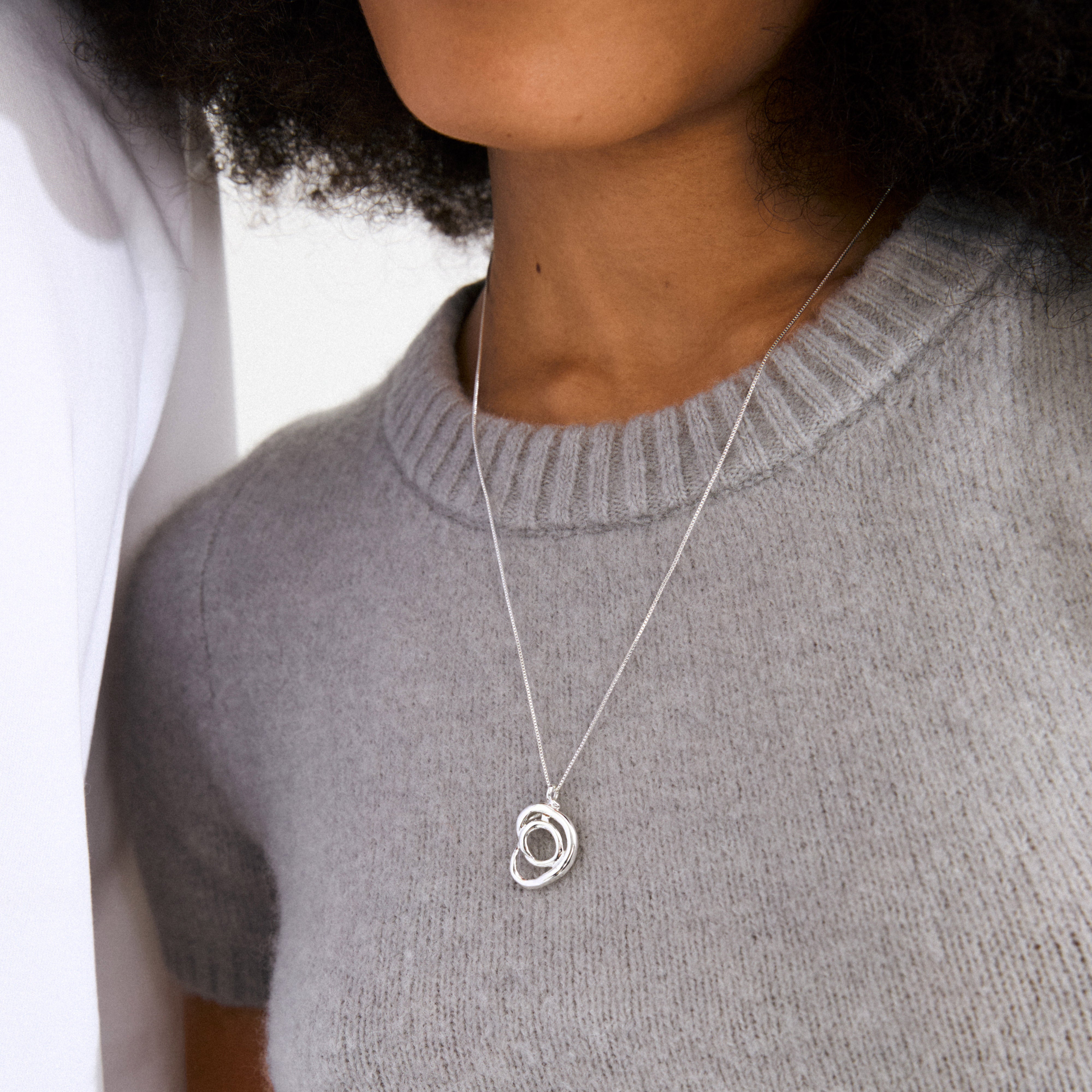 DIEGO necklace silver-plated featuring a twisted doodle pendant, adjustable length, crafted from 99% recycled materials, combining artistic style with sustainable fashion.