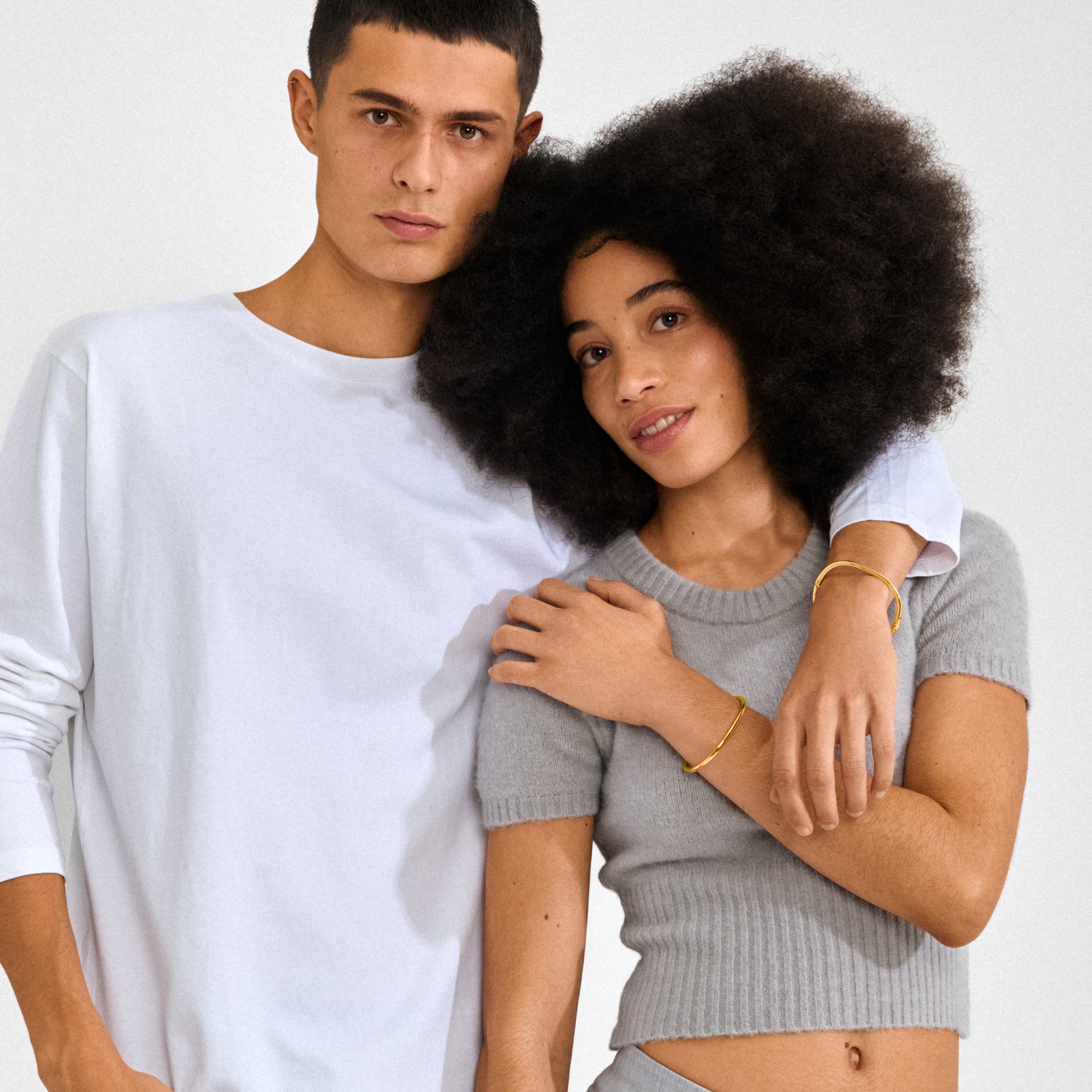 ALAIA gold-plated bangle, featuring a classic design with a discreet click clasp, crafted from 99% recycled materials for an elegant yet eco-friendly accessory.