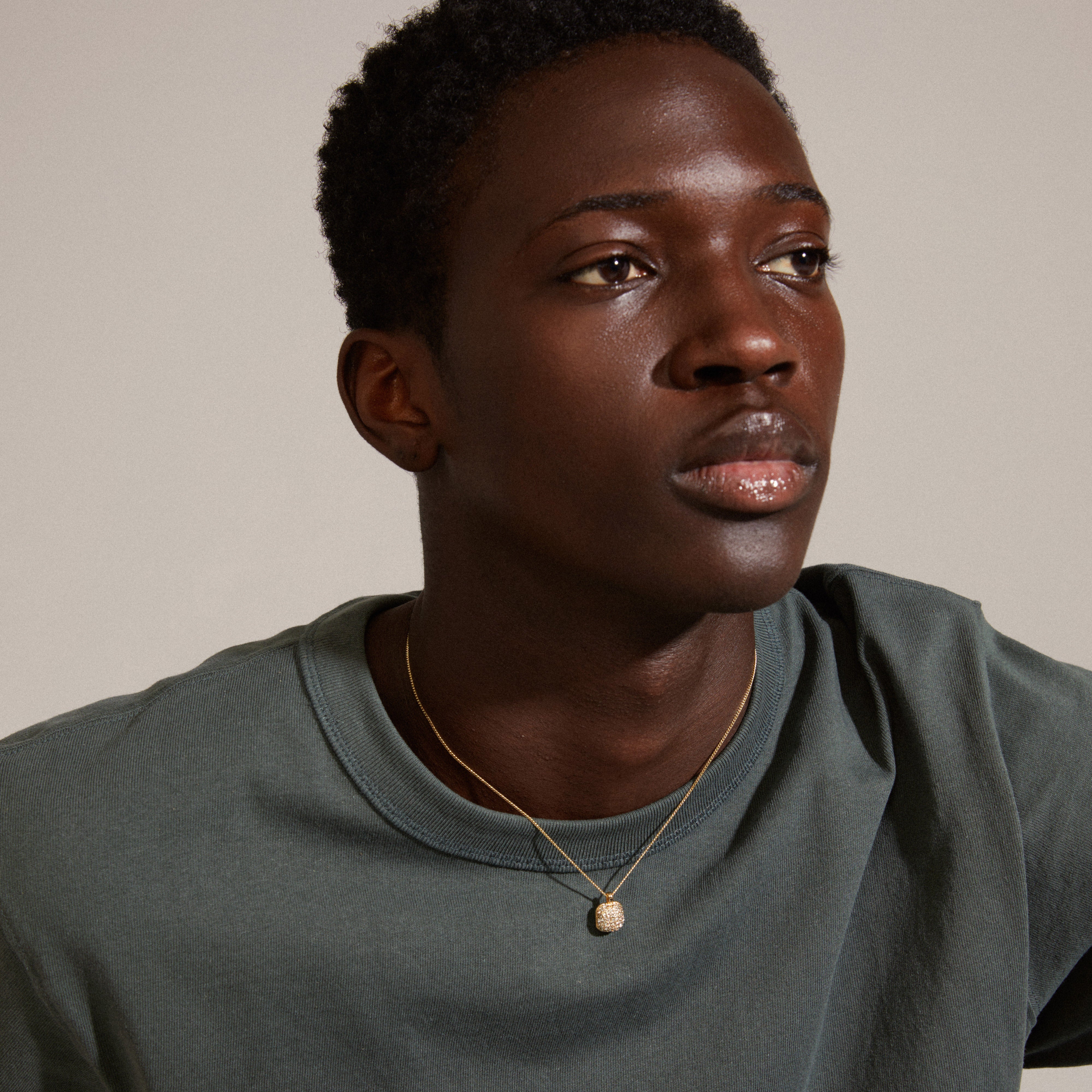 Man wearing the CINDY crystal pendant necklace gold-plated, featuring a slim chain and sparkling Preciosa crystals, highlighting a chic and trendy accessory from Pilgrim.