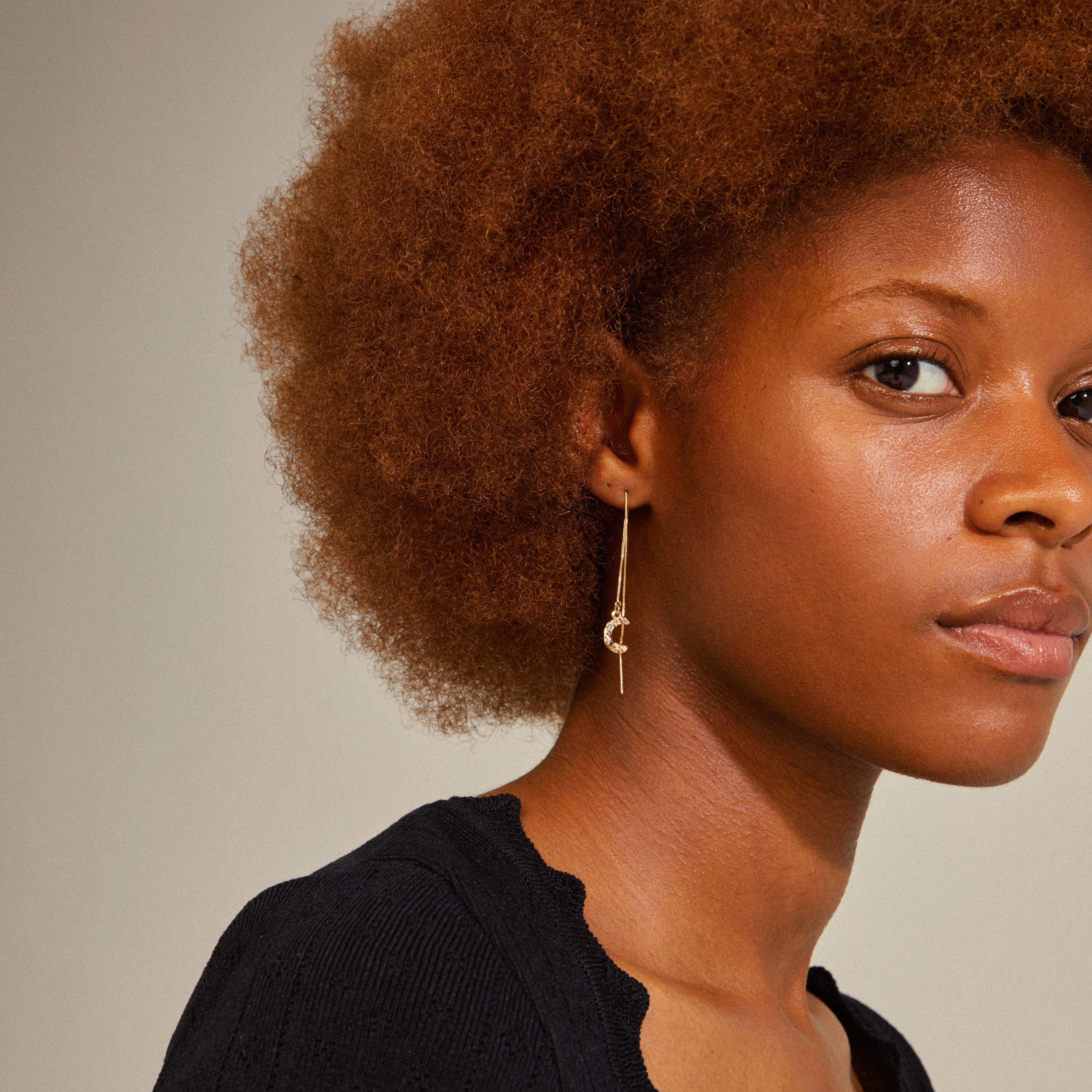 REMY chain earrings gold-plated with crescent moon pendants worn by a woman with curly hair, showcasing their timeless elegance and style.