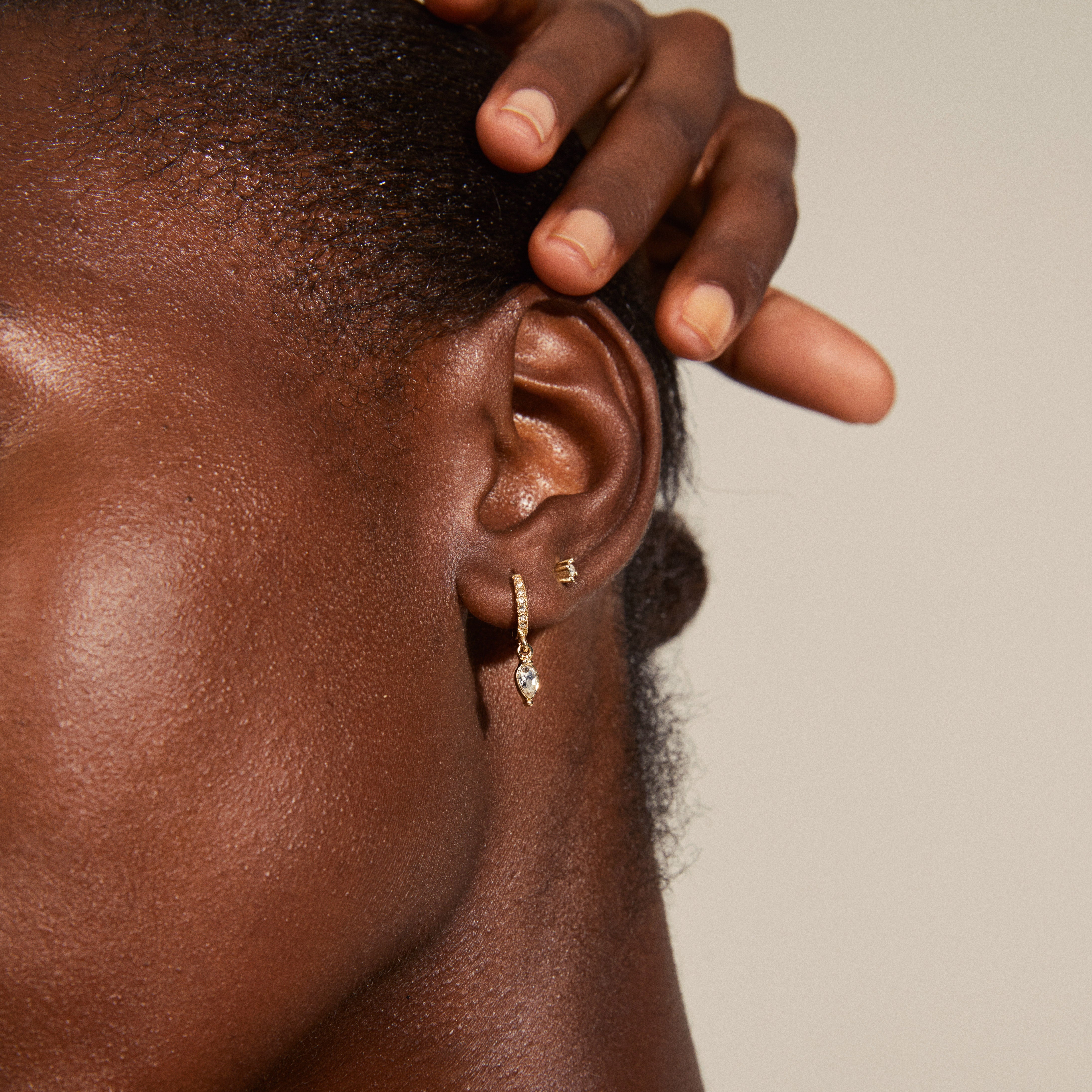 Gold-plated ELZA crystal earrings 2-in-1 set featuring small ear studs and huggie hoops with Preciosa crystals and teardrop pendant visible on a person.