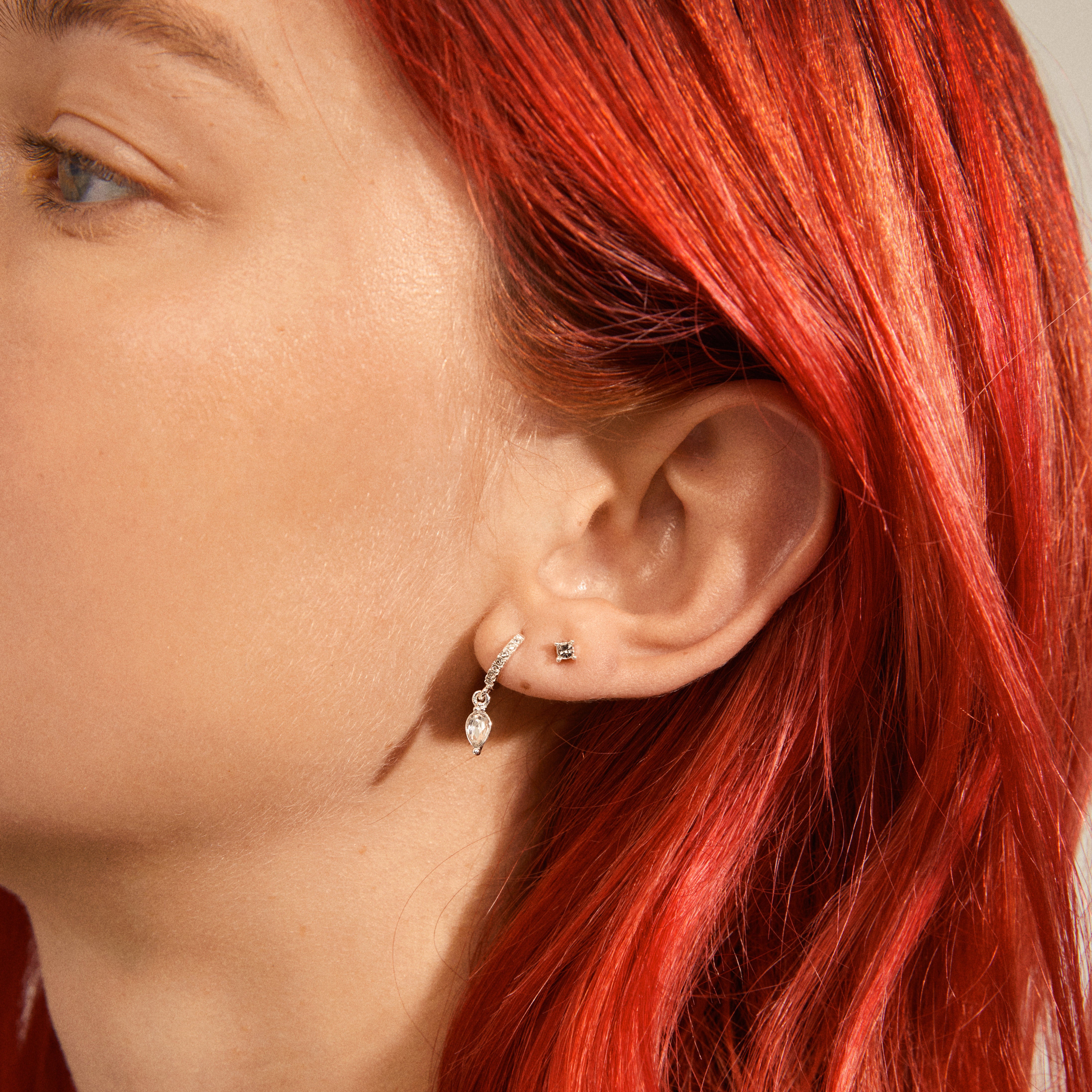 ELZA crystal earrings 2-in-1 set silver-plated featuring small ear studs and teardrop pendant huggie hoops with sparkling Preciosa crystals for a classy, trendy look.