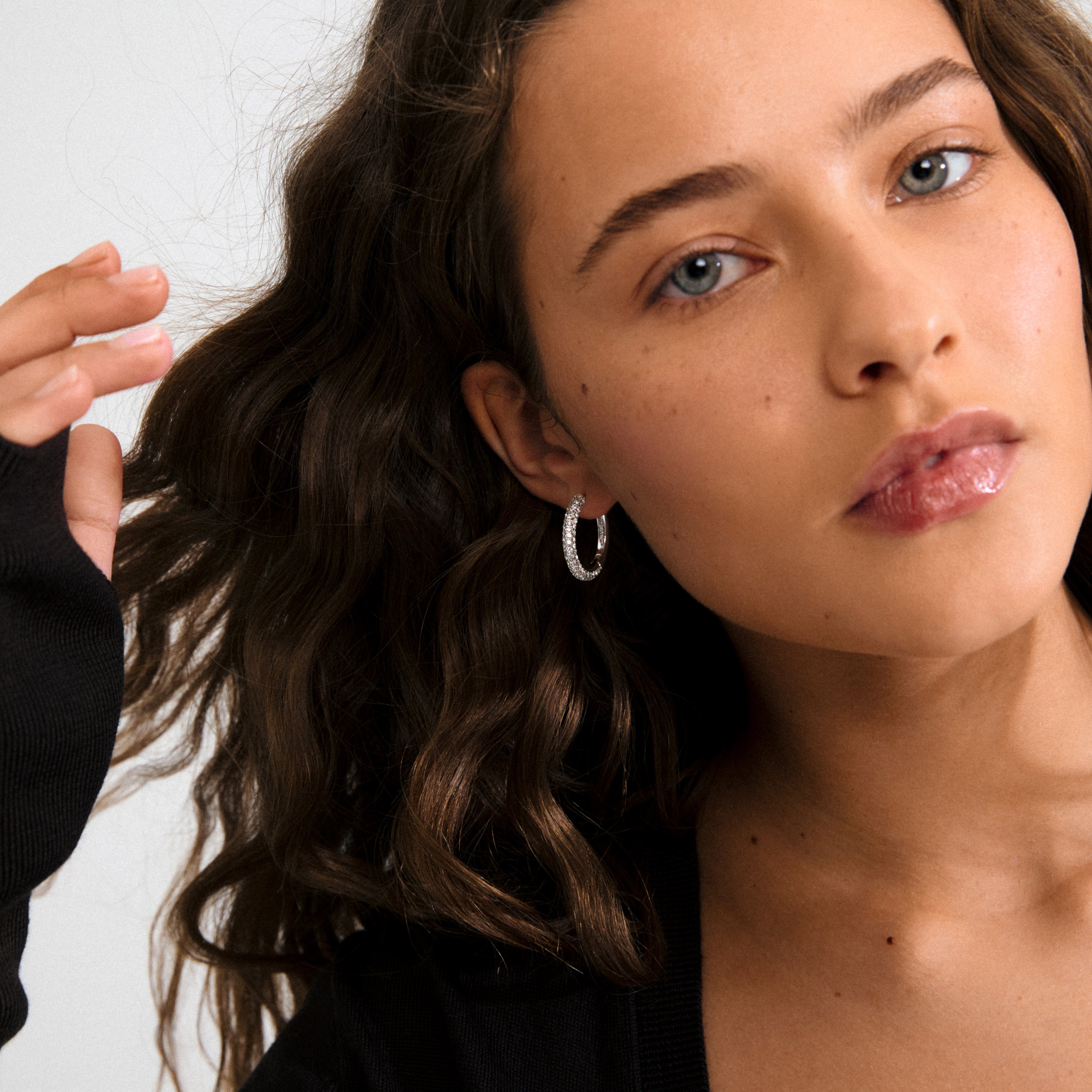 TATUM large silver-plated hoops with sparkling Preciosa crystals, featuring easy click clasps, ideal for versatile day-to-night wear, crafted from 97% recycled material.