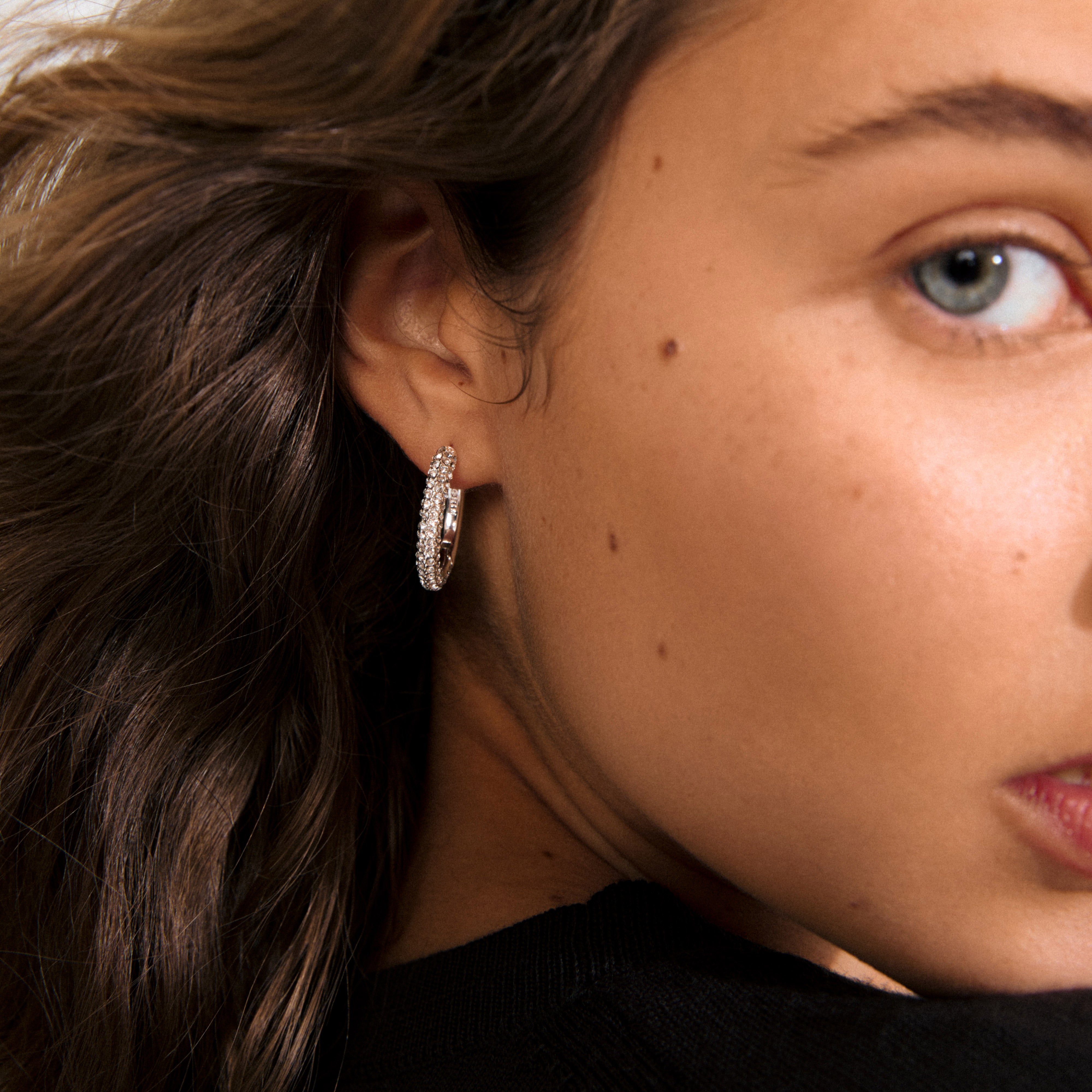 TATUM large hoops silver-plated with sparkling Preciosa crystals, offering understated luxury for versatile day-to-night elegance. Features easy click clasps, crafted from 97% recycled material.