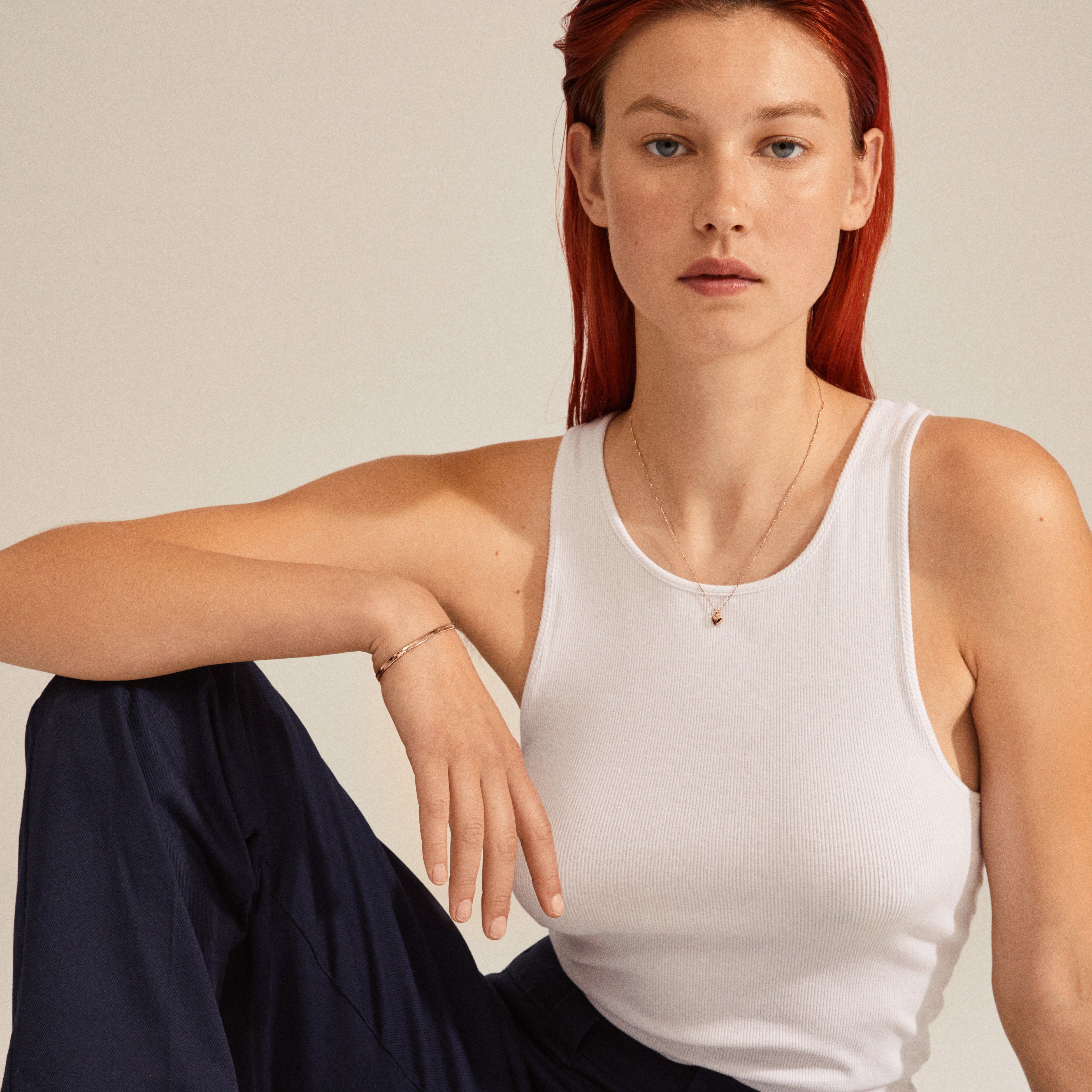 EFIA silver-plated huggie hoop earrings with engraved starry details, worn by a red-haired woman in a white tank top, showcasing elegance and style.
