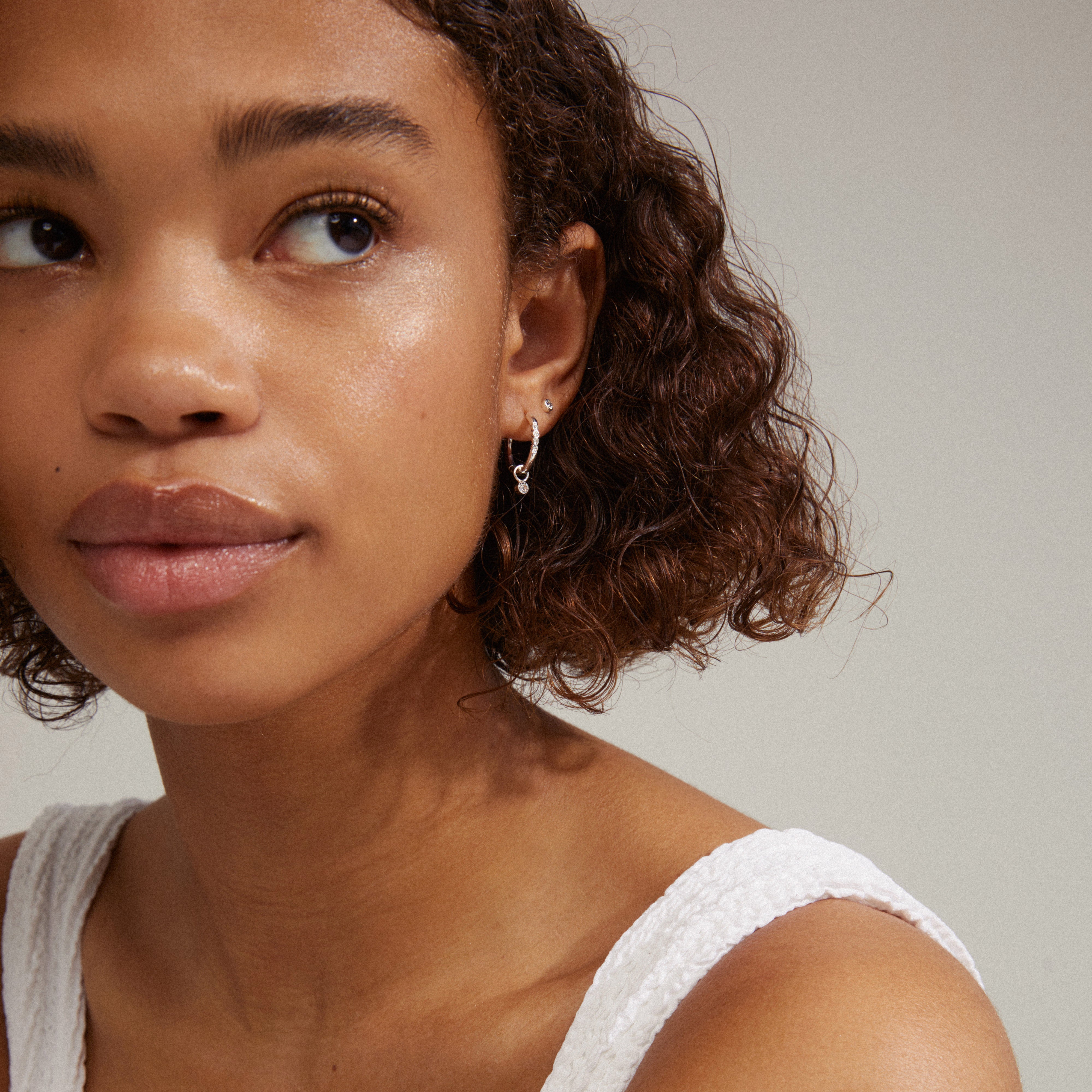 Silver-plated ELNA crystal earrings 2-in-1 set featuring simple studs and crystal-adorned hoops, offering versatile styling options for personalized, trendy looks.