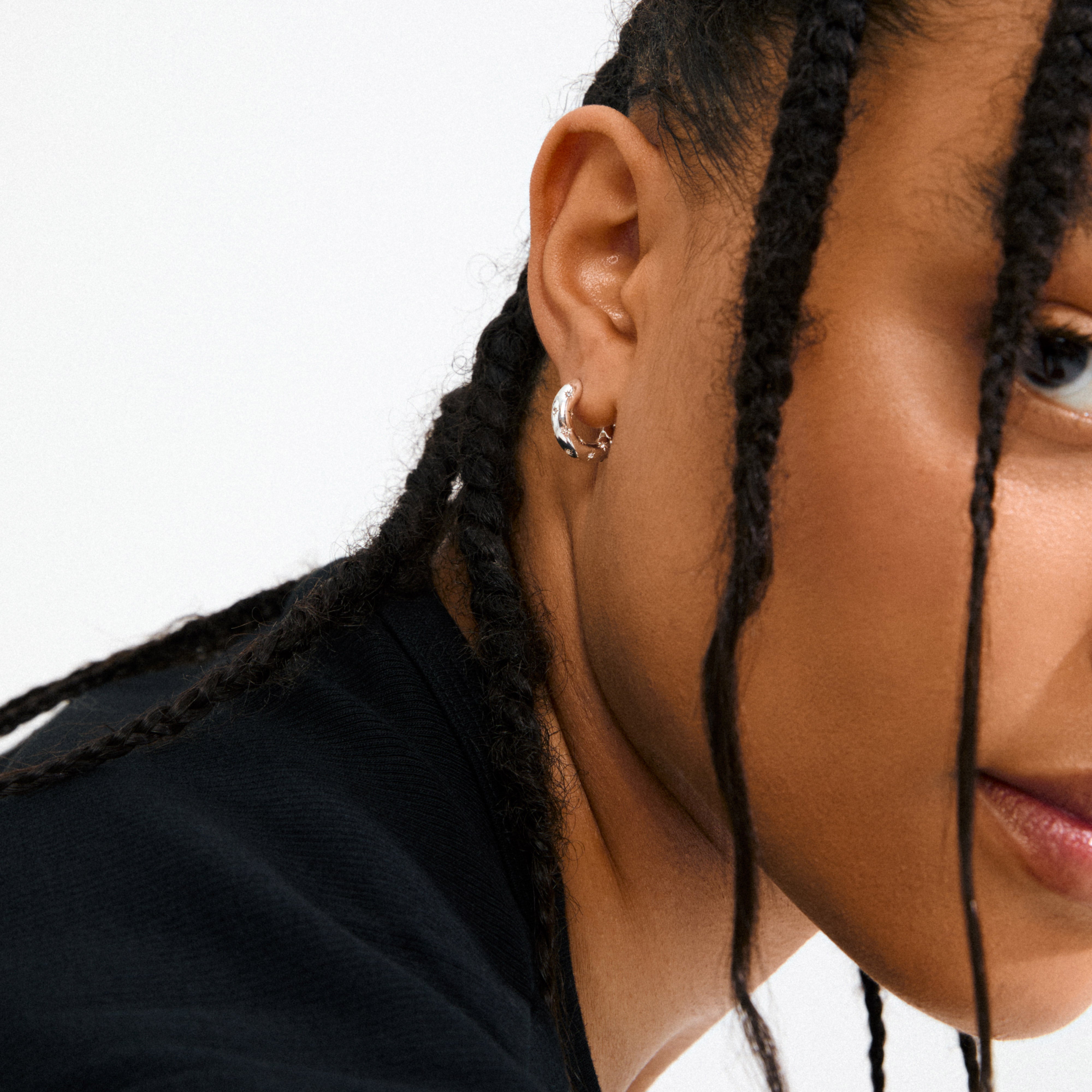 NEVAEH hoops silver-plated, featuring chunky huggie design with petite Preciosa crystals, crafted from 97% recycled material, offering a touch of sparkle for any occasion.