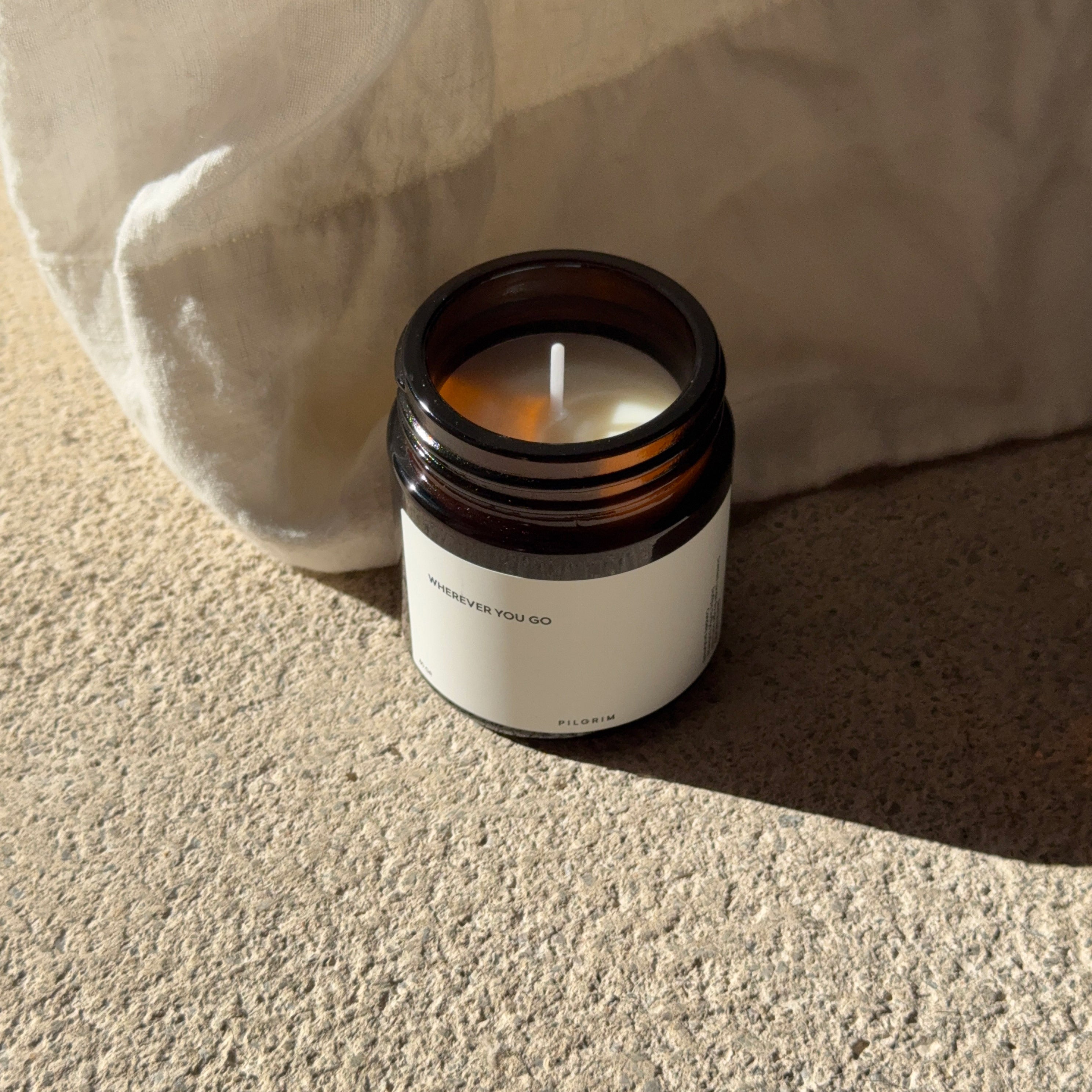 PILGRIM Scented candle in a jar, crafted from sustainable rapeseed wax, offers a calming sandalwood fragrance with an Eco-Tex certified cotton wick for a serene burn.