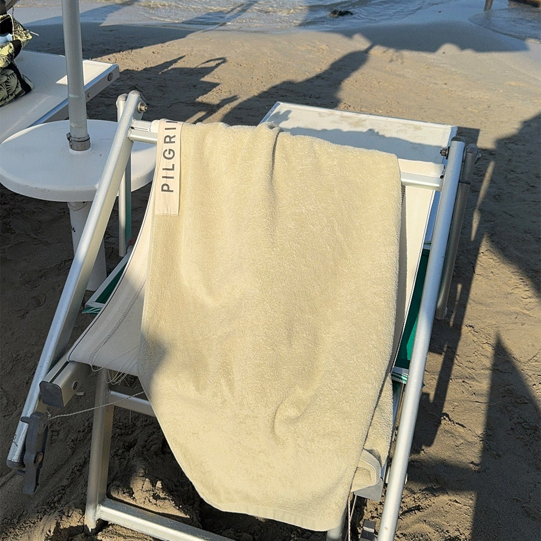 Beach Towel, 100 x 150 cm, beige with Pilgrim logo, crafted from organic cotton for ultimate comfort, perfect for poolside relaxation or beach outings.